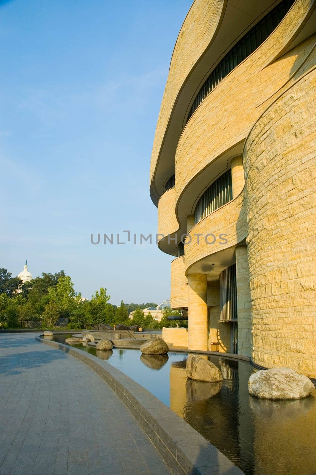 Reflection of a national museum in water, National Museum of the American Indian, The Mall, Washington DC, USA