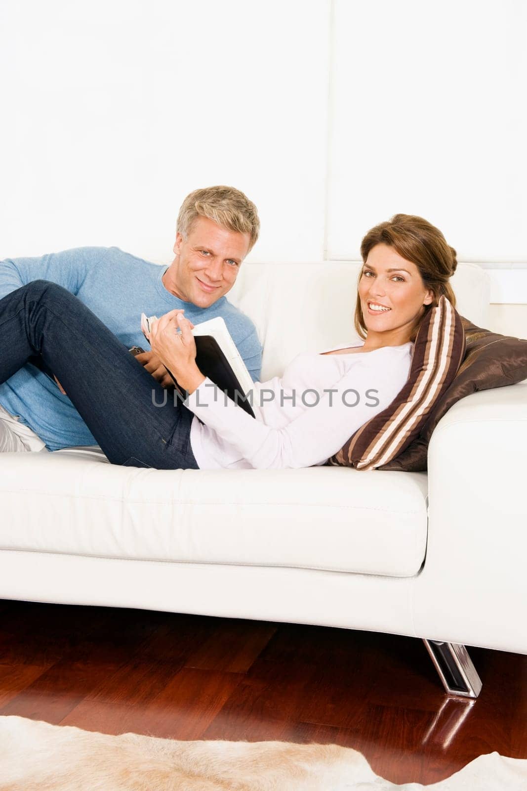 Couple reading a book on the couch