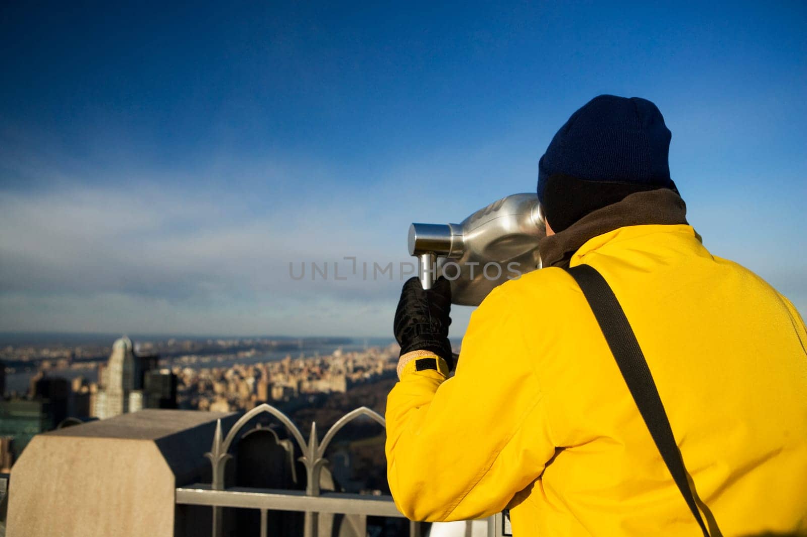 Rear view of a person looking through a coin_operated binocular, Manhattan, New York City, New York State, USA