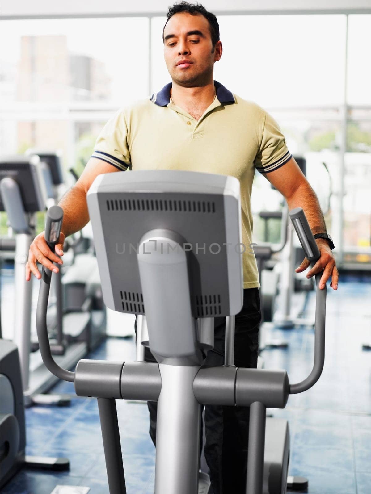 Mid adult man exercising on a treadmill in a gym