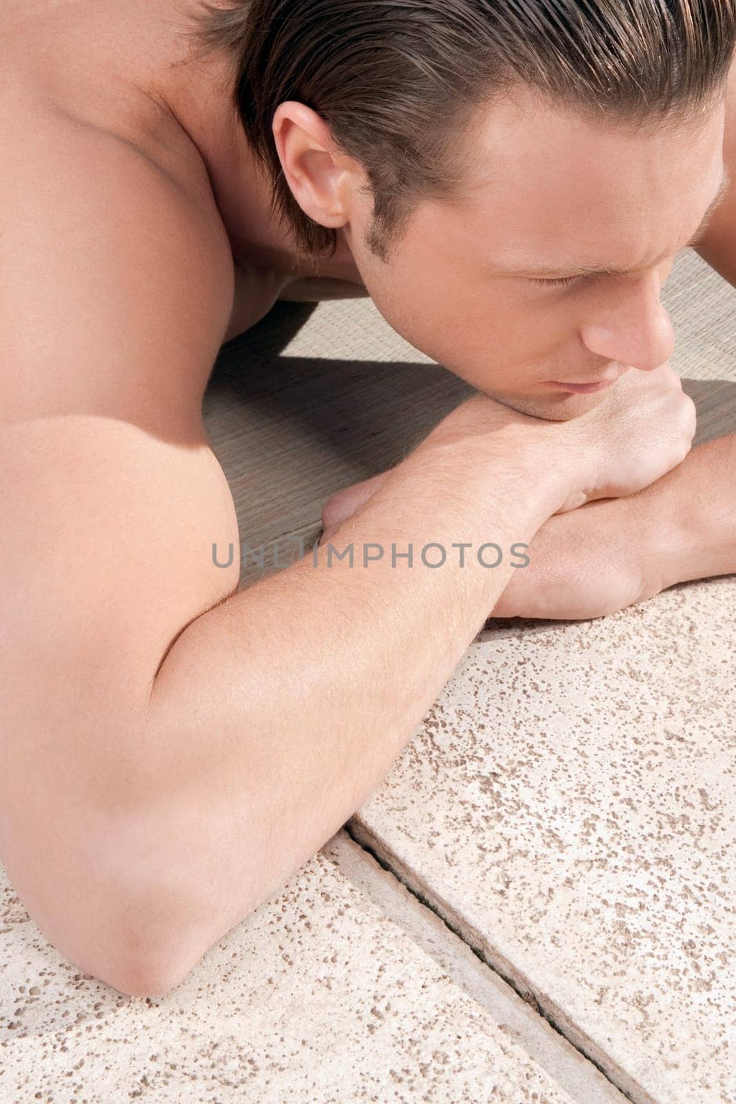 Man resting at the poolside