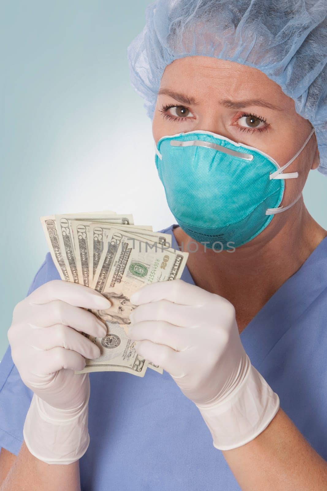 Female surgeon holding currency notes