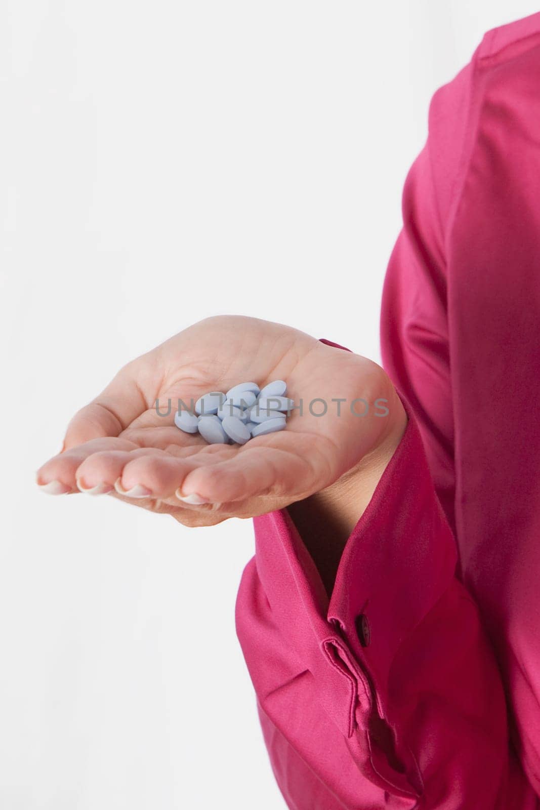 WomanŽs hand holding pills