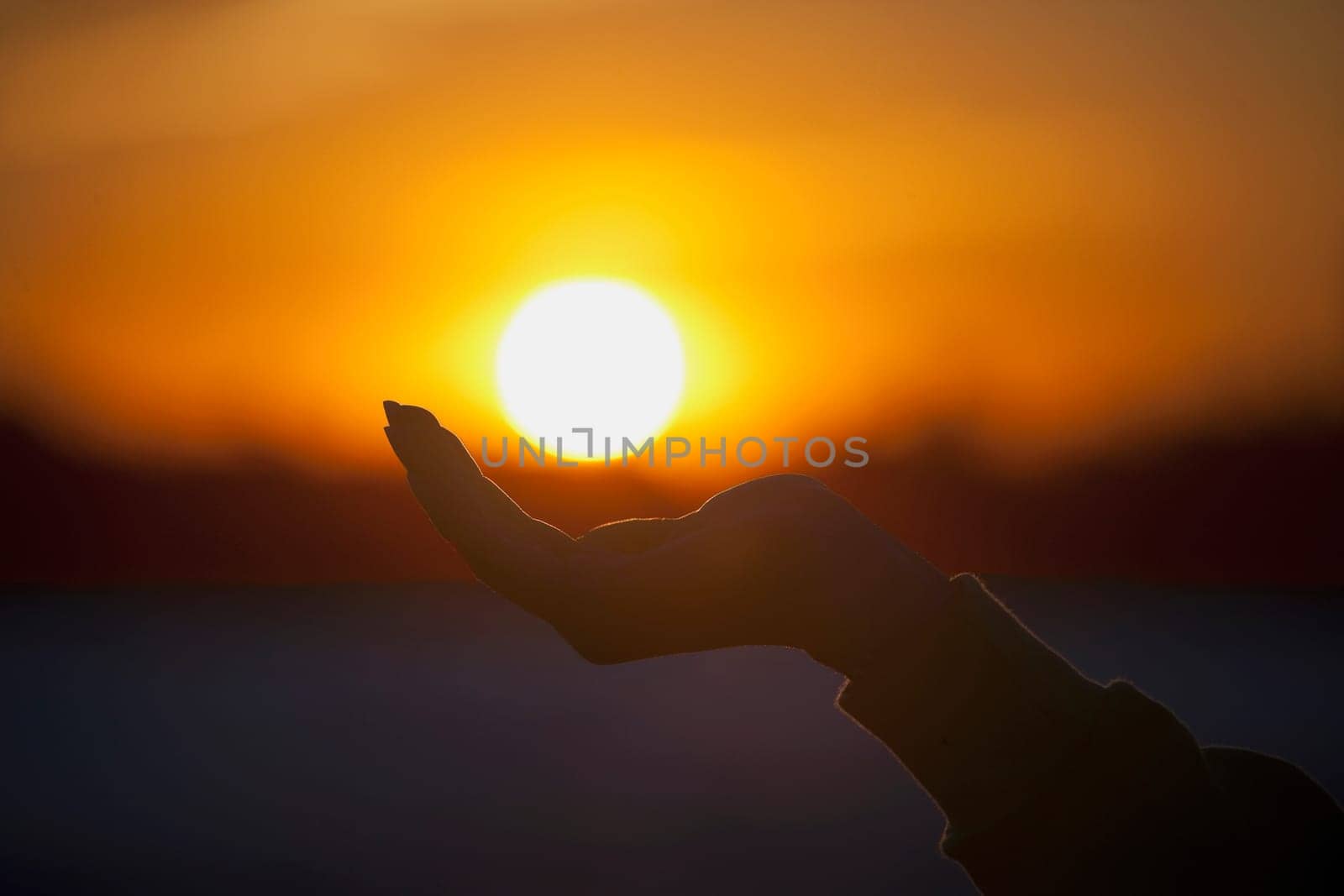 Person cupping hand under sun