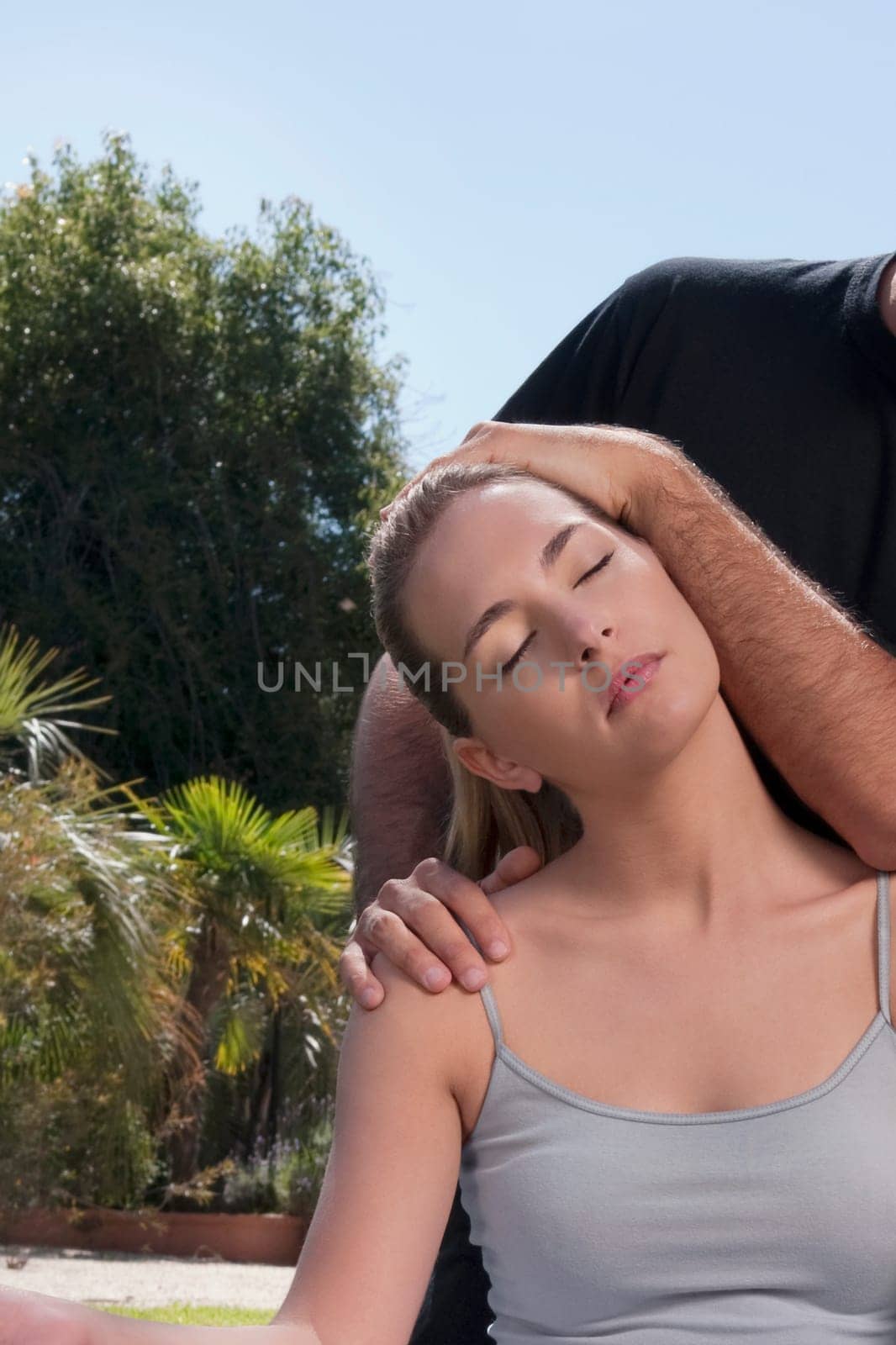 Man assisting a woman during yoga practice