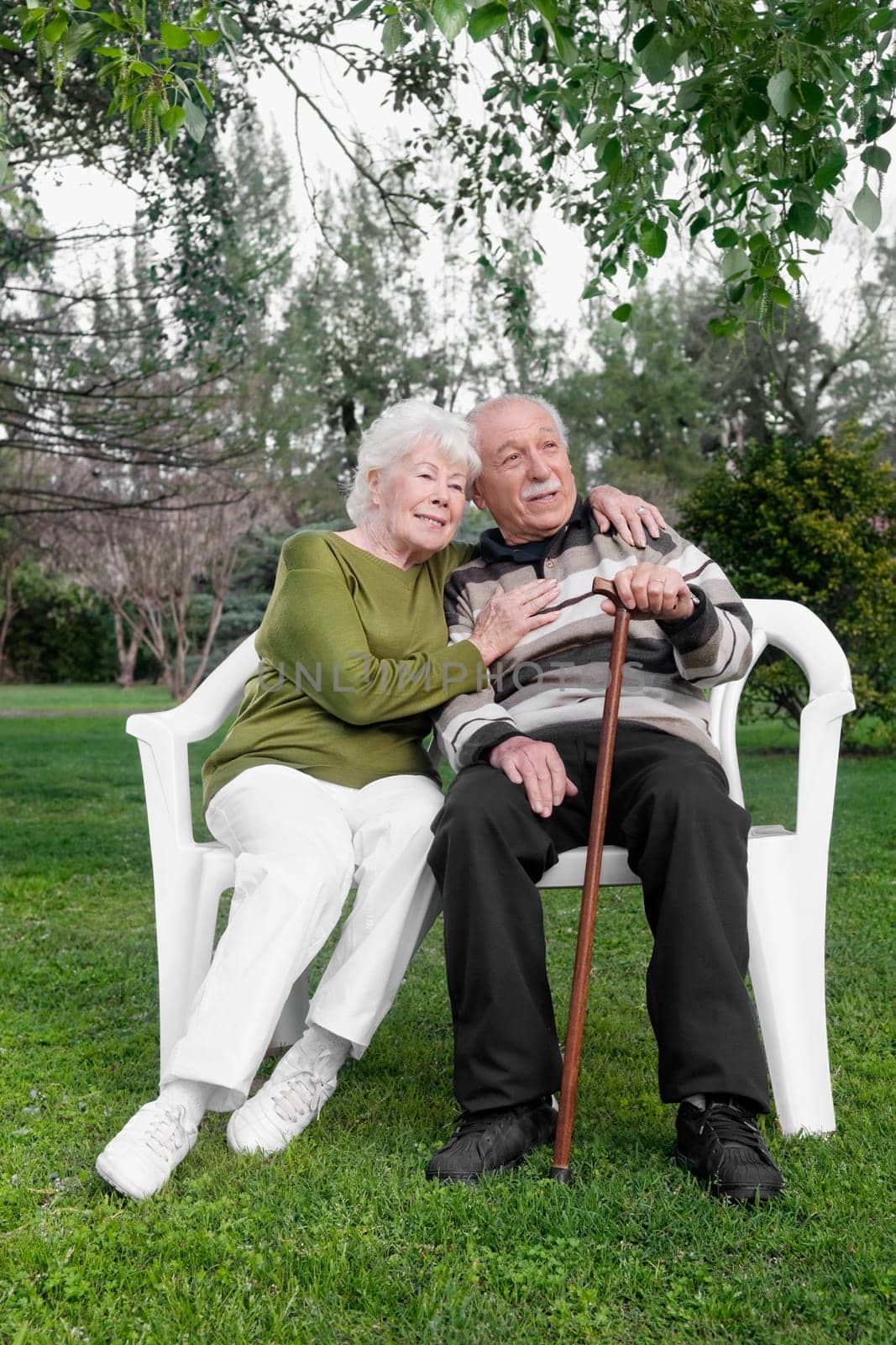 Couple sitting on chairs in a park