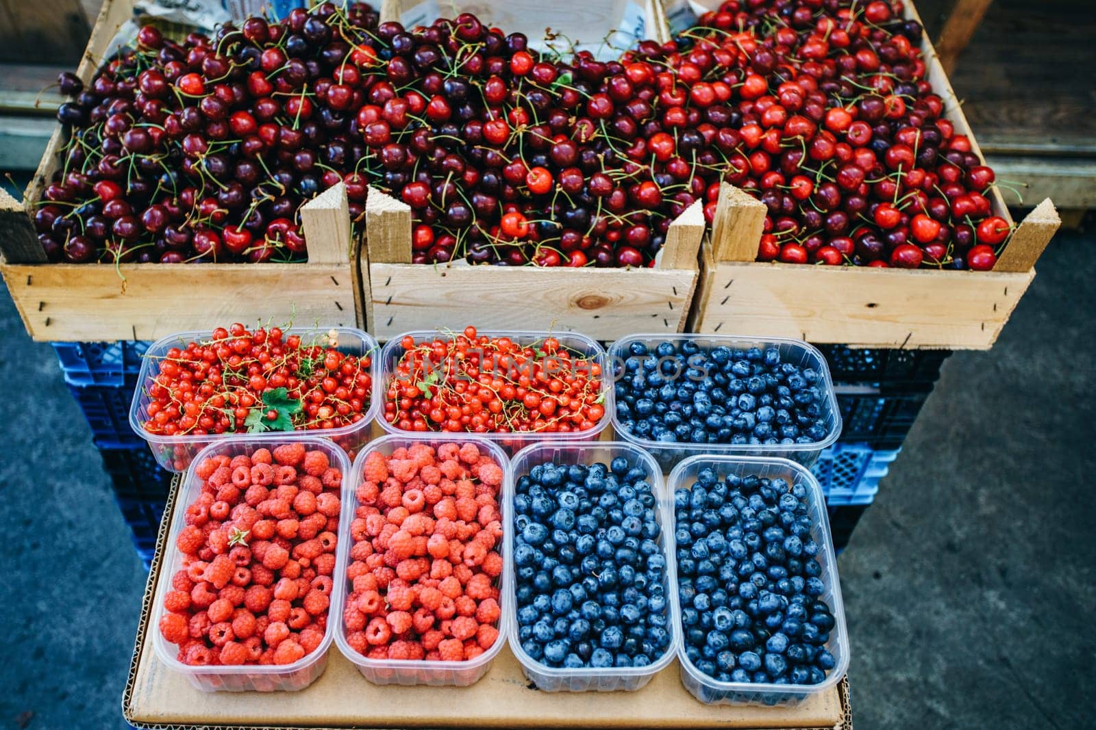 A mix of fresh berries on the market, strawberries, blueberries, raspberries, blackberries, cherries and red currants