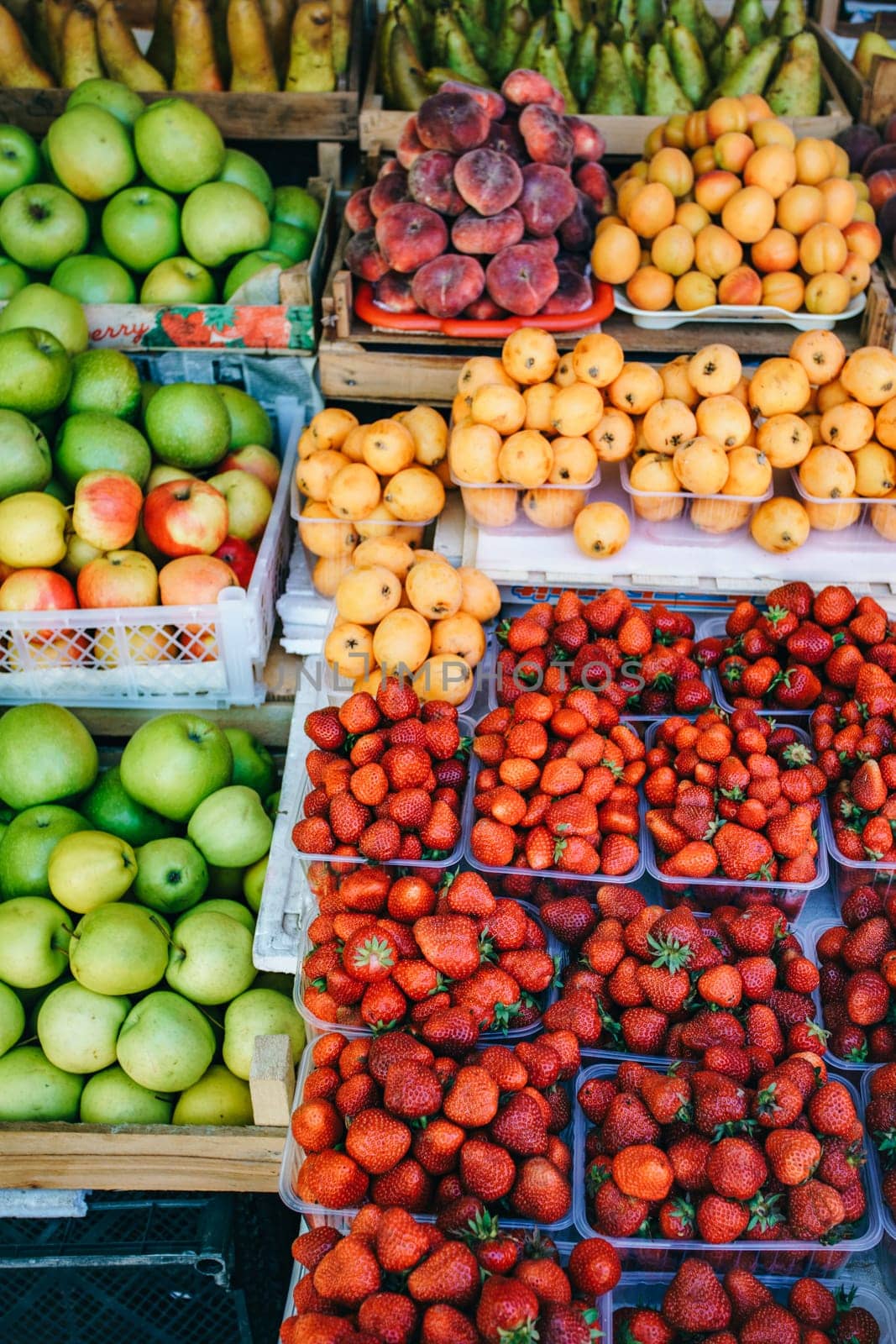 Fresh fruit in the market. Apricots, peaches, cherries, apples