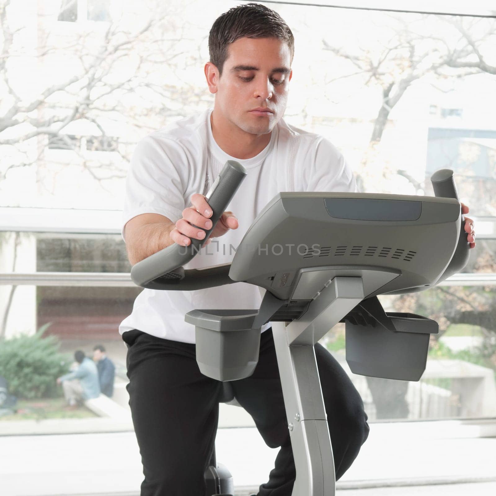 Man working out on an exercise bike in a gym