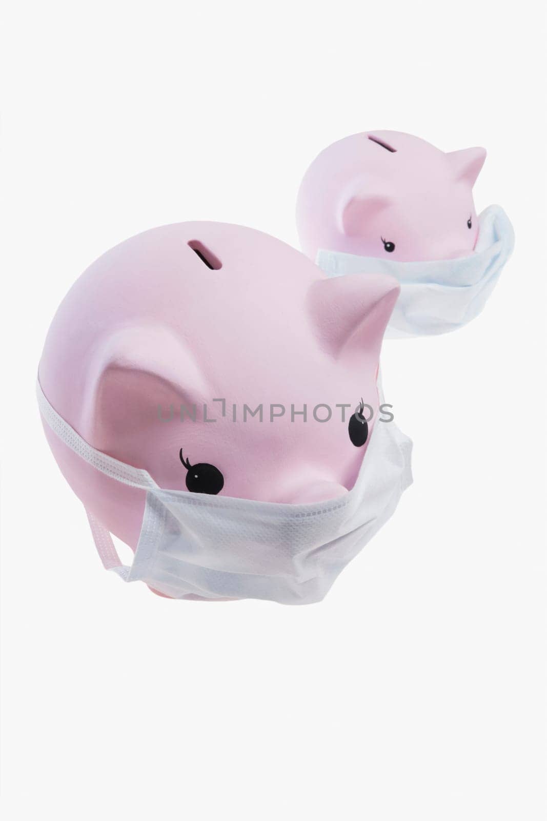 Close_up of piggy banks wearing flu masks