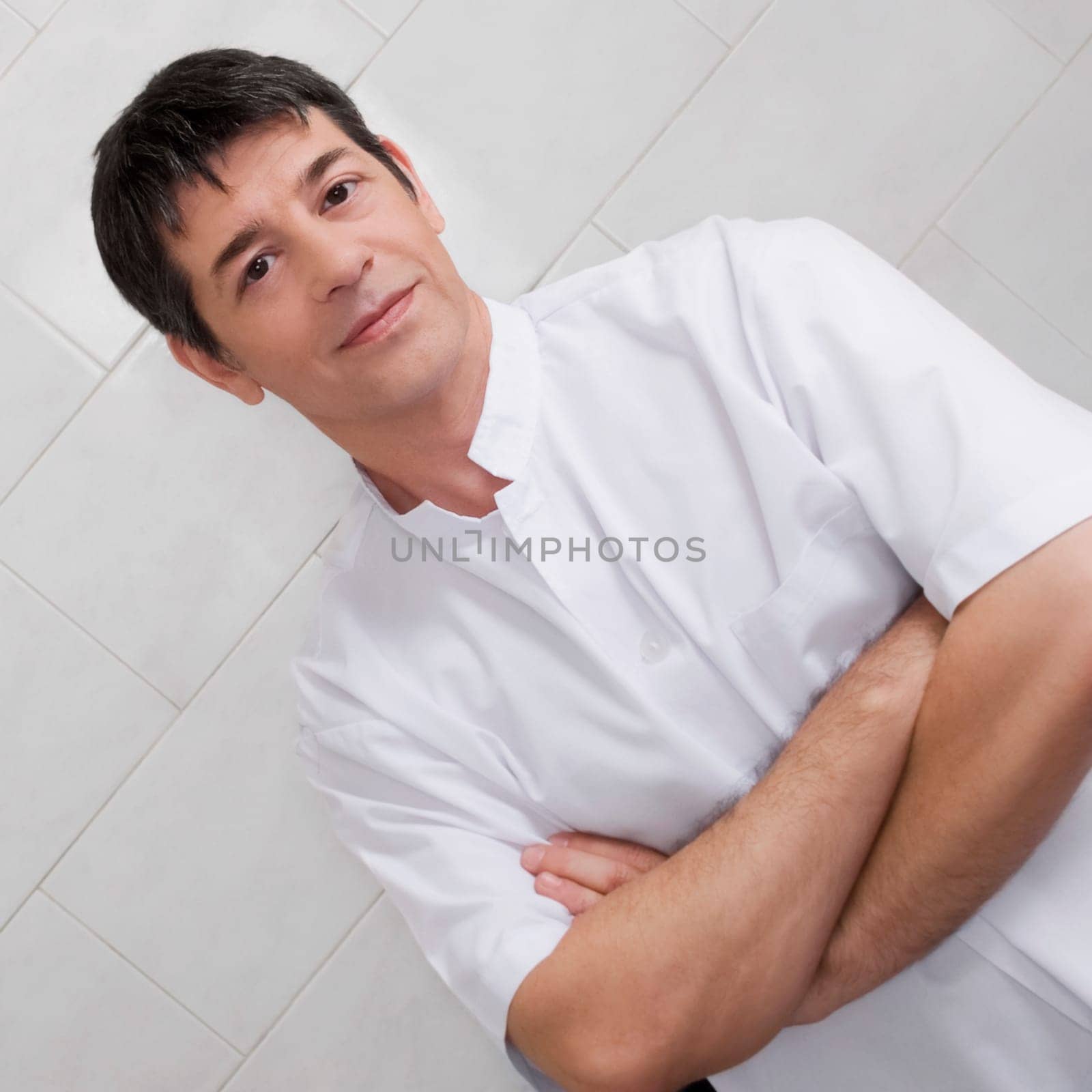 Vet standing with his arms crossed