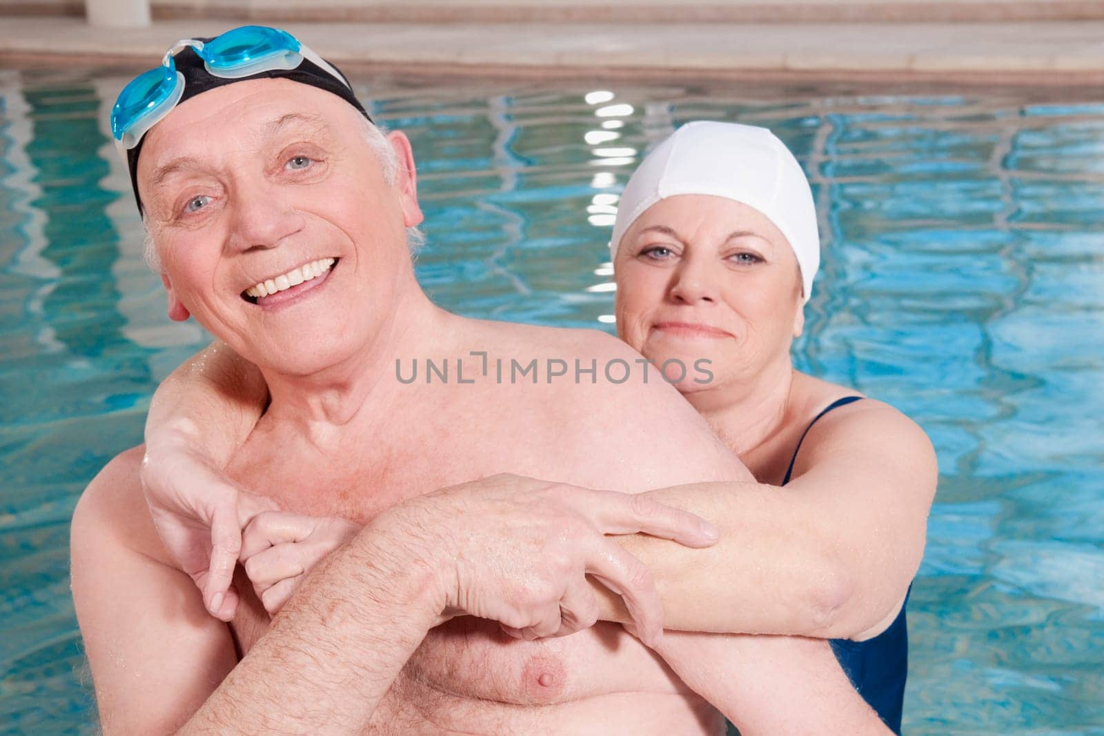 Portrait of a couple smiling in a swimming pool
