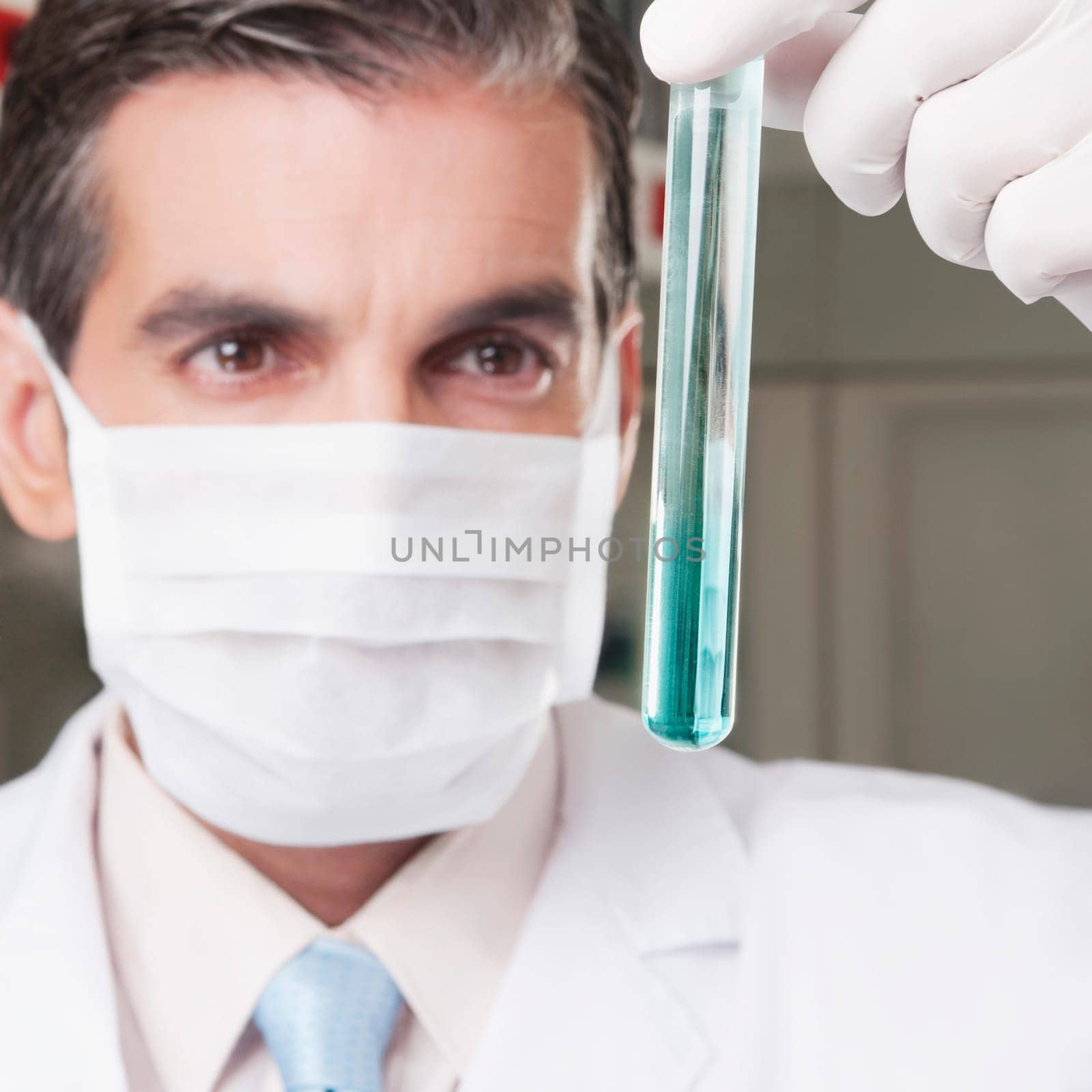 Lab technician analyzing sample in a test tube