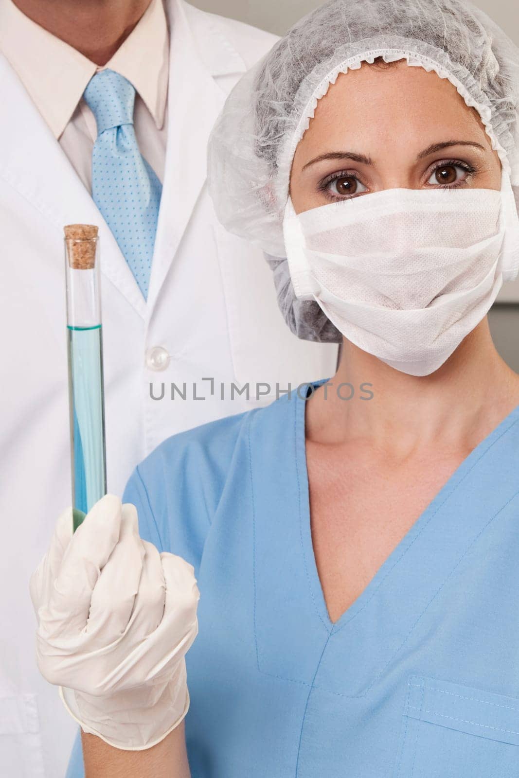Lab technicians analyzing a sample in a test tube