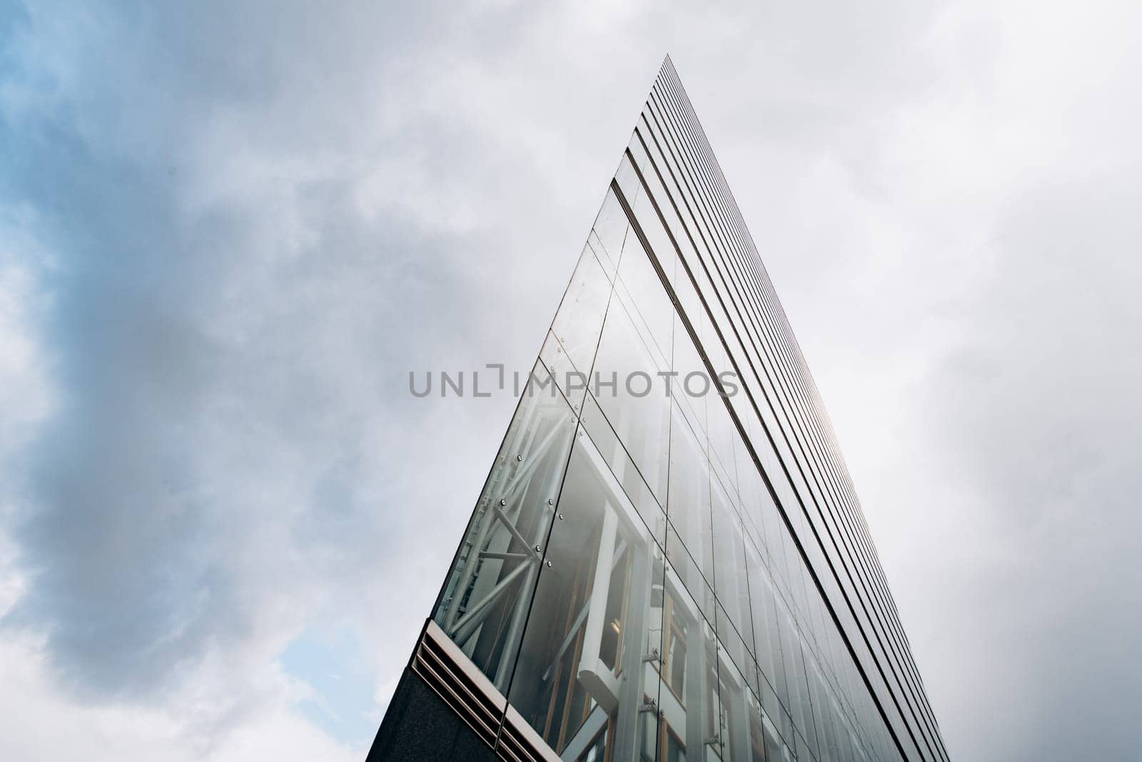 Dramatic view of skyscrapers against cloudy sky. View of the skyscraper from below