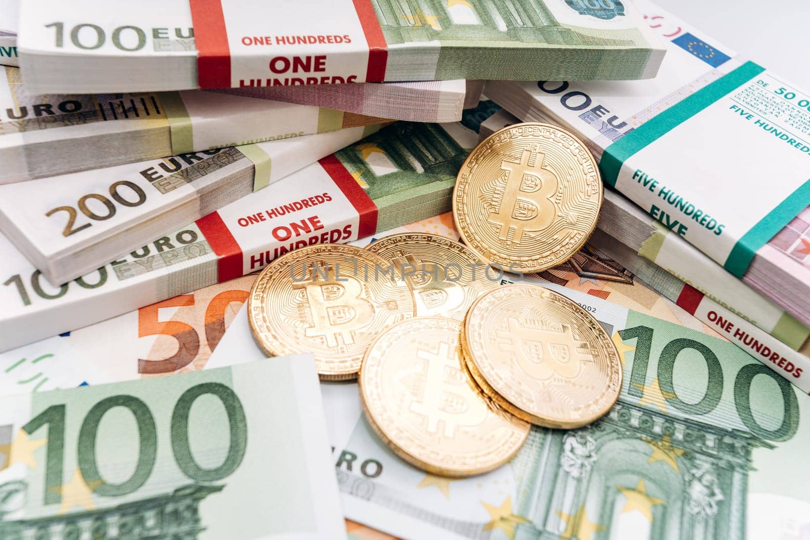 Crypto currency concept - a bitcoin with euro bills. Bitcoin and Euro banknotes. Cryptocurrency lies on the money