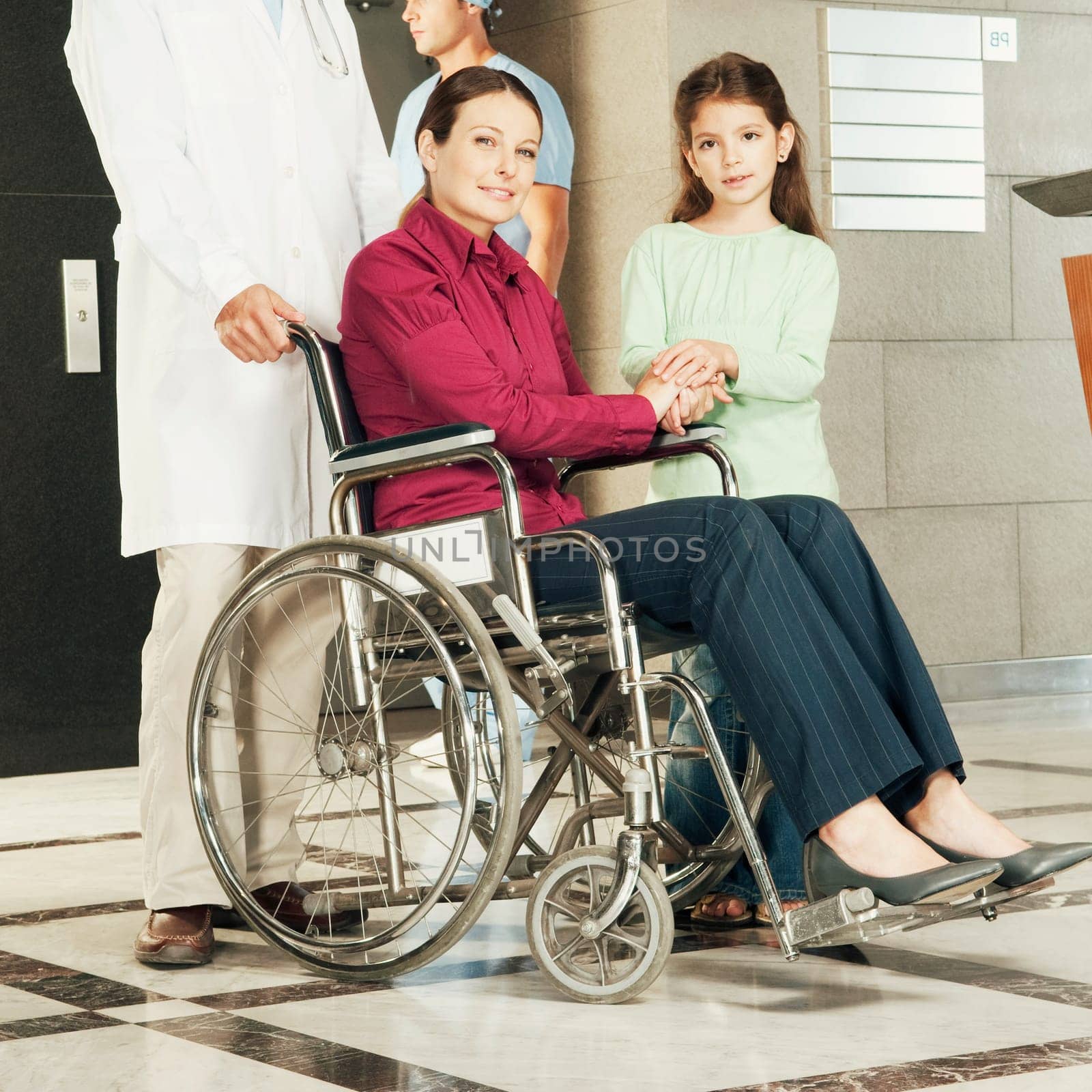Doctor pushing a woman in a wheelchair