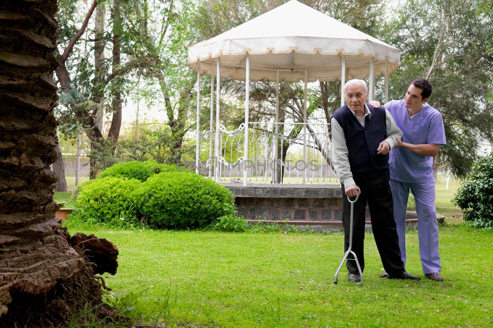 Healthcare worker assisting a patient in walking