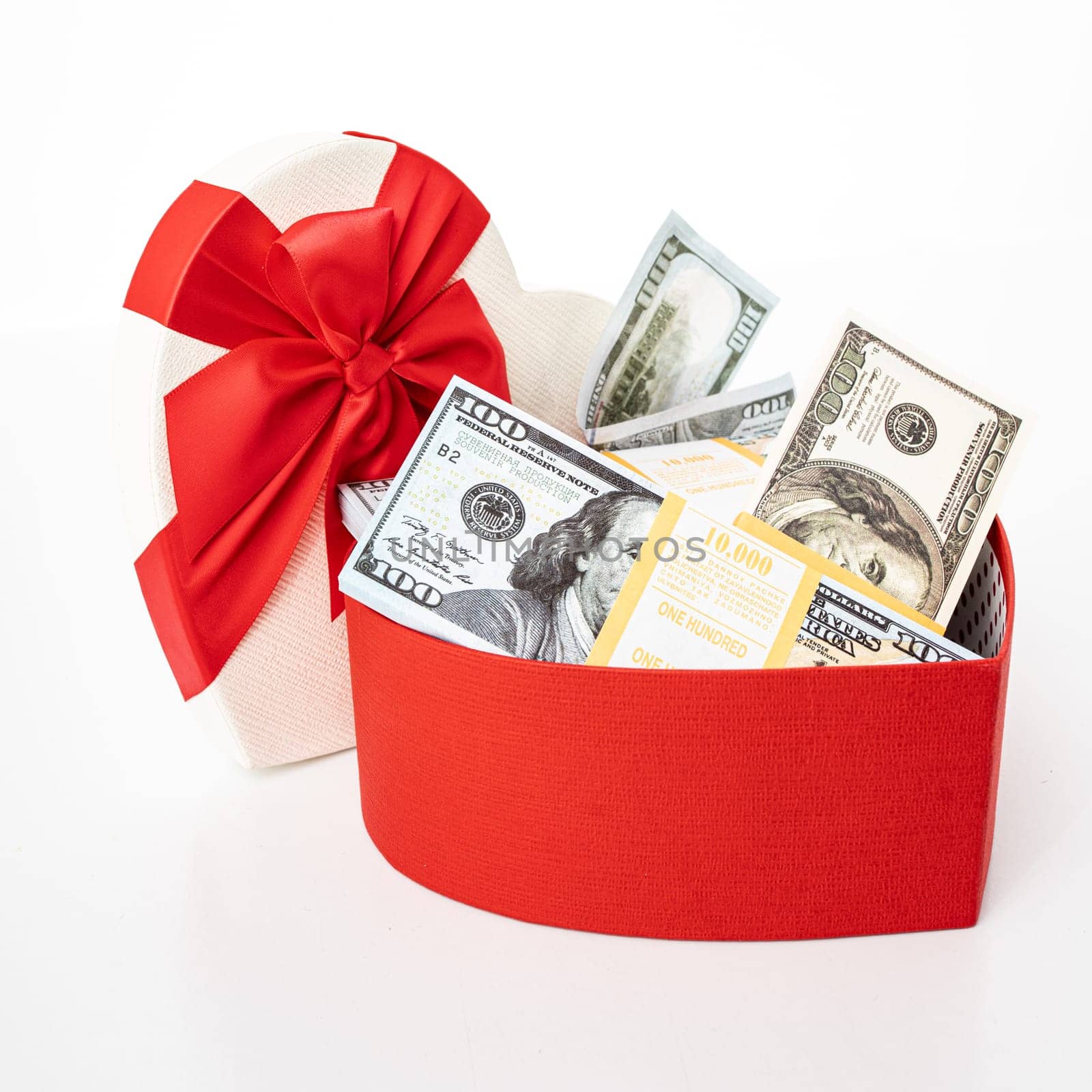 Dollars in a  gift box on a white background.  Valentine's Day. Birthday. Saving money.