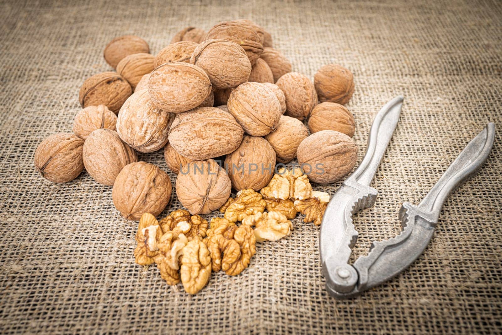 Walnut kernel background. Nutcracker with walnut