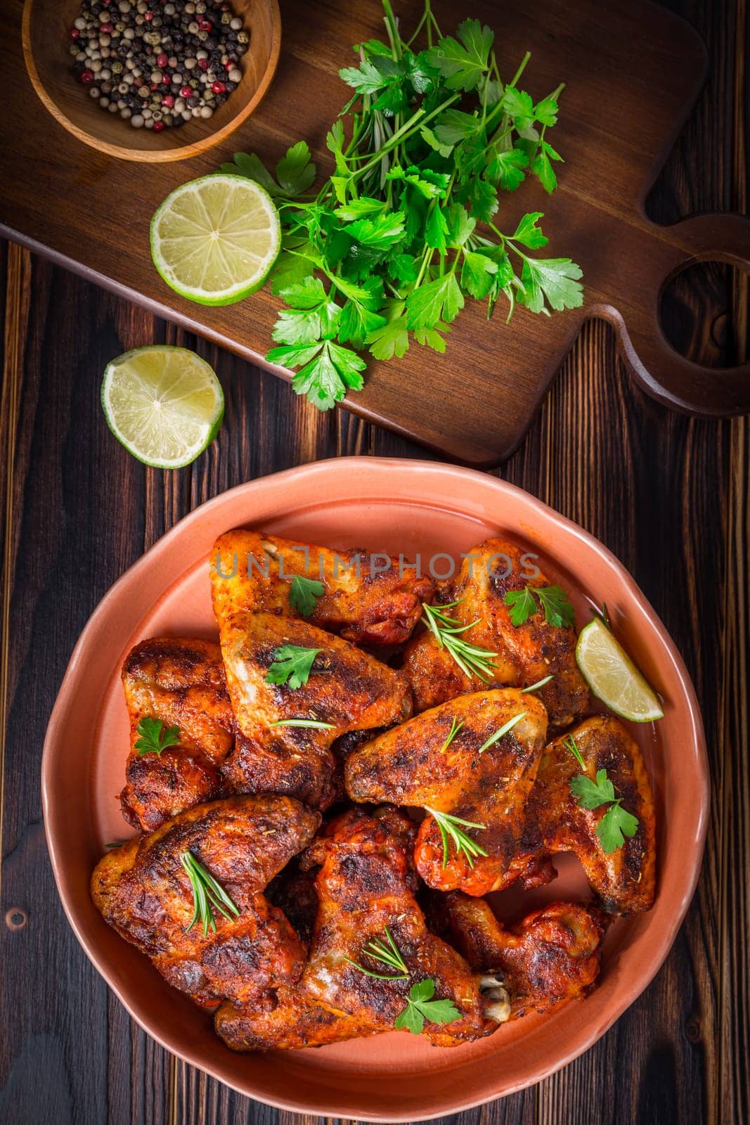 Hot and Spicey Buffalo Chicken Wings with ingredients on wooden background