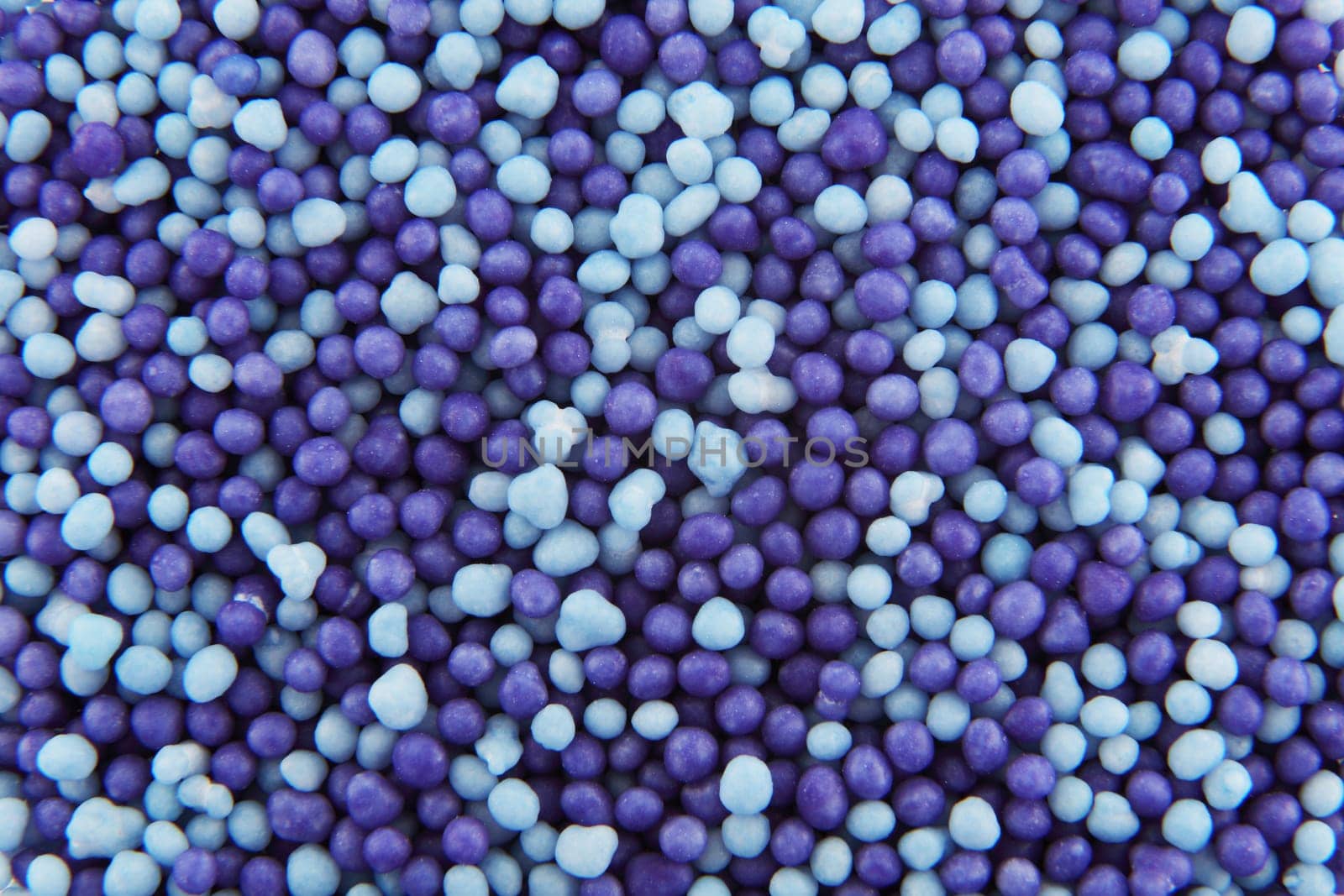 Light blue and purple hundreds and thousands sprinkles sugar beads used for decorating cakes and desserts