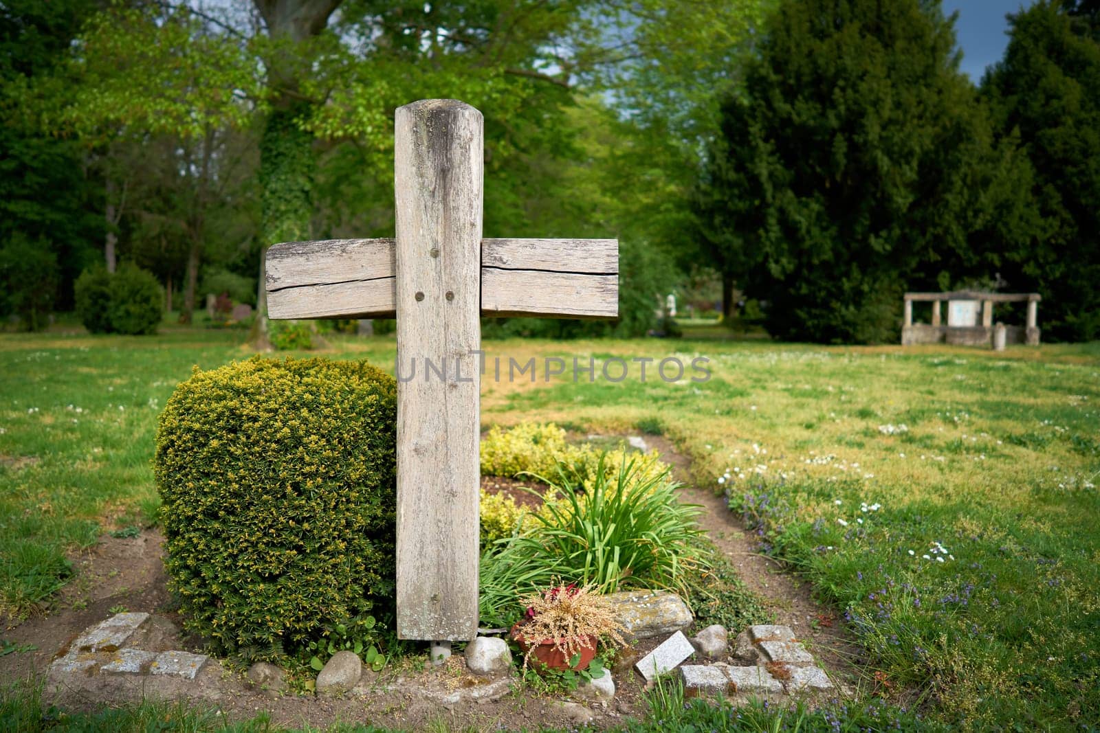 Cross made of wood on a grave in the cemetery