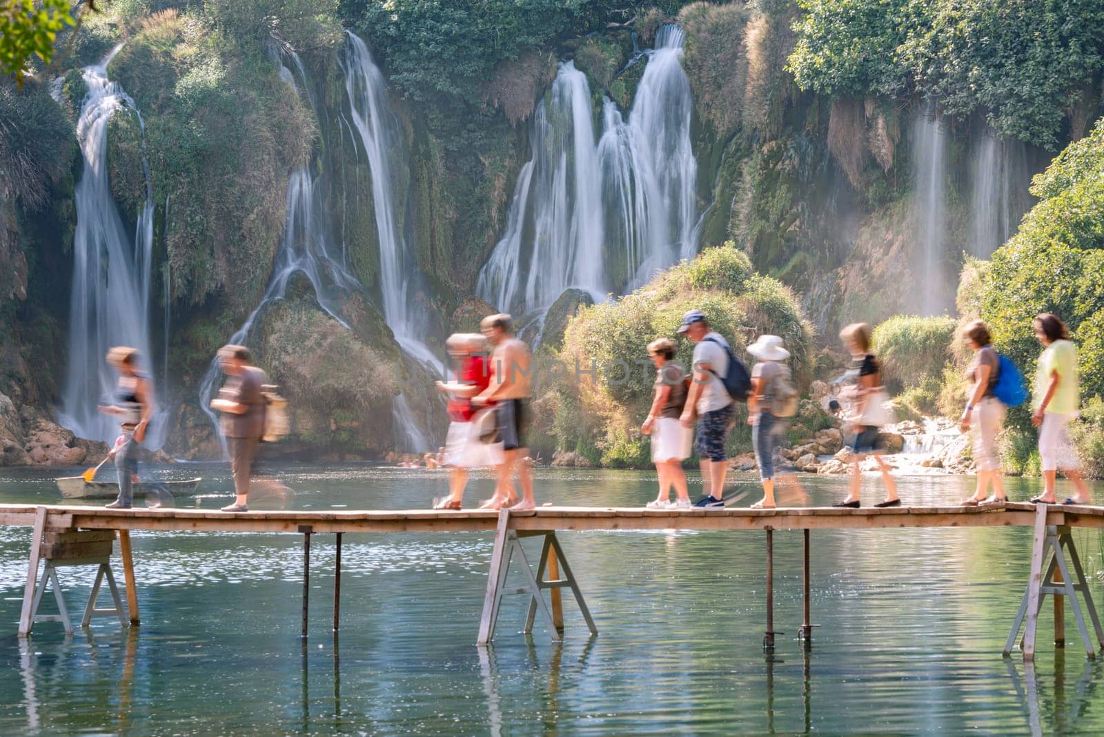 Kravice Waterfalls, Bosnia and Herzegovina, Europe.  People on bridge at waterfall.