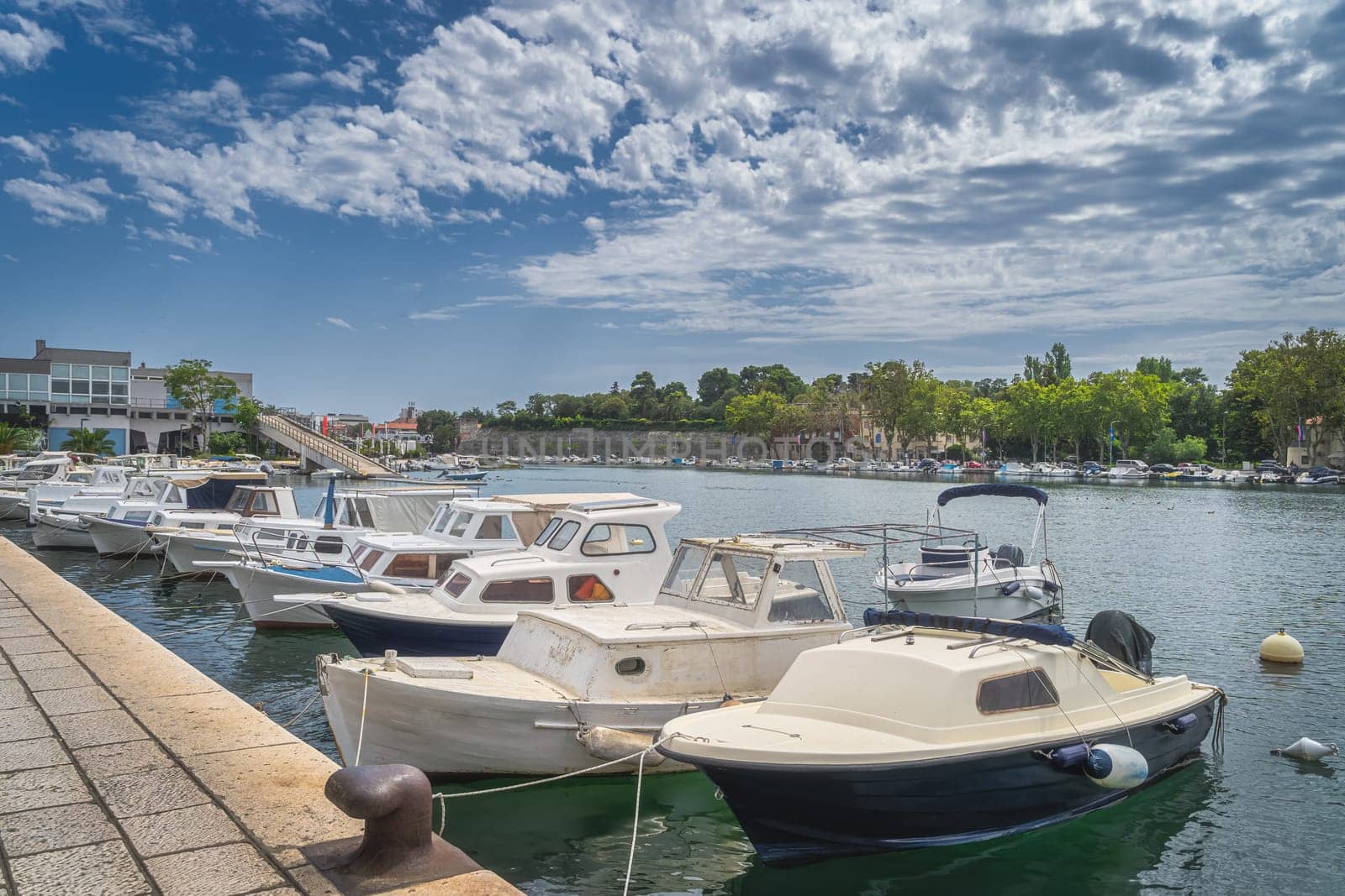Marina or harbour with moored many motorboats in Zadar bay. View on walled old town, Croatia