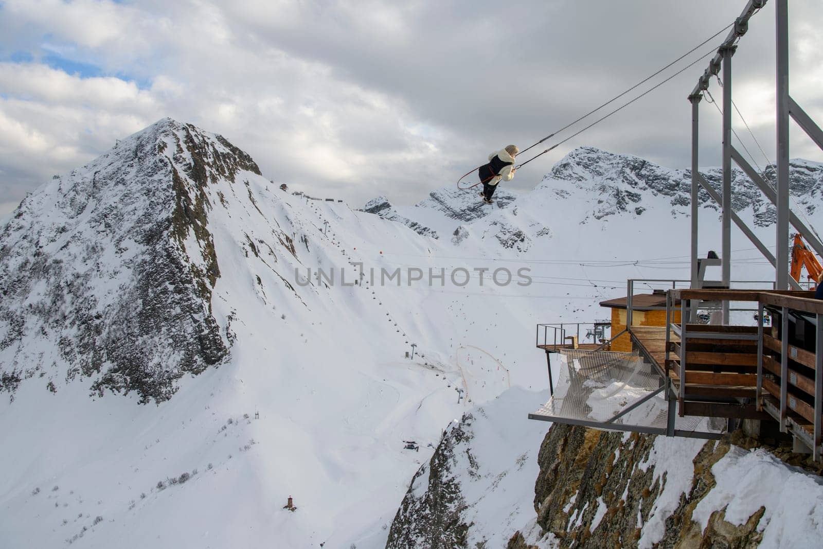 Sochi  Russia - January 02  2021: Tourists ride on the mega-swing of the Gorki Fly panoramic site at the Krasnaya Polyana ski resort