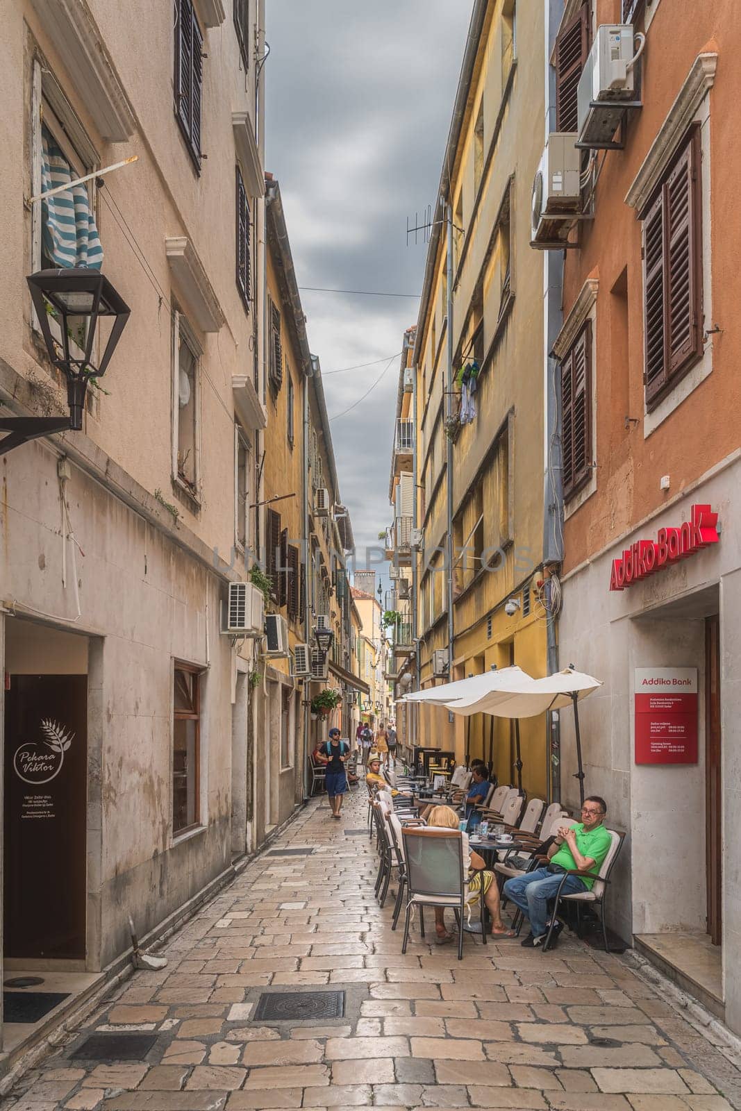 Zadar, Croatia, July 2019 Tourists relaxing in outdoor restaurants in narrow streets of the old town