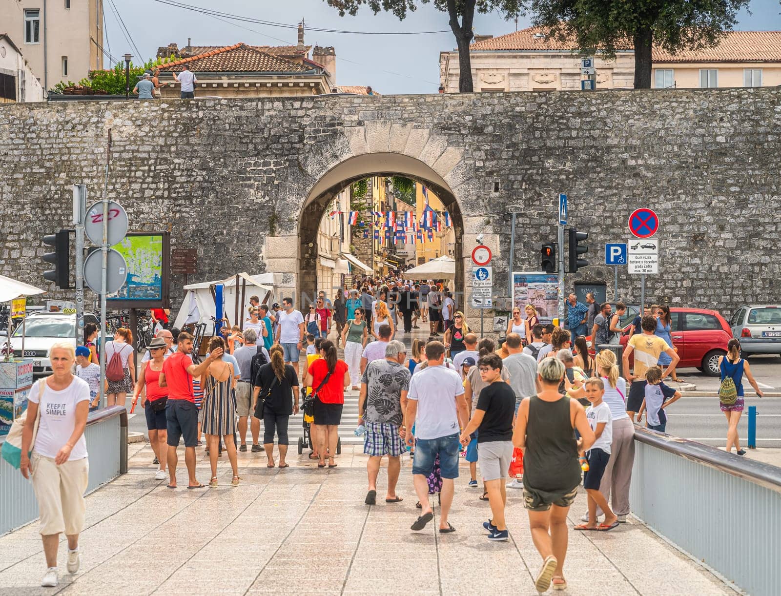 Zadar, Croatia, July 2019 Tourists visiting beautiful, narrow streets of the old town of Zaton with ancient, early Romanesque architecture