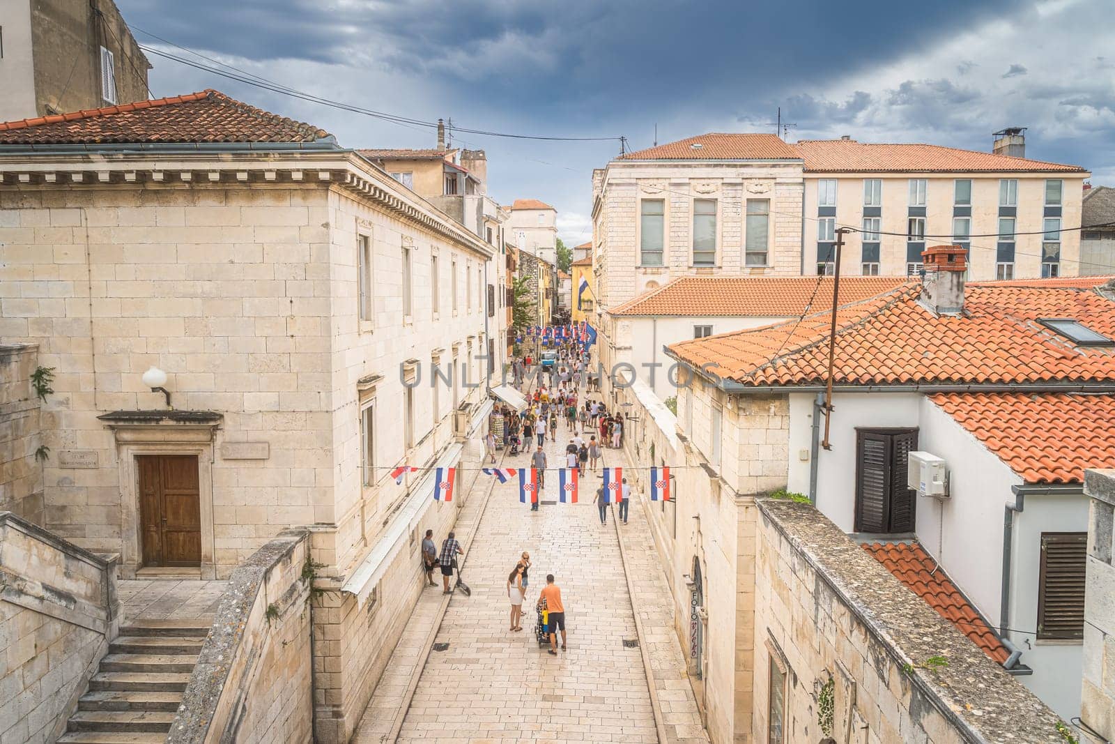 Zadar, Croatia, July 2019 Top view on tourists visiting beautiful, narrow streets of the old town of Zaton with ancient, early Romanesque architecture