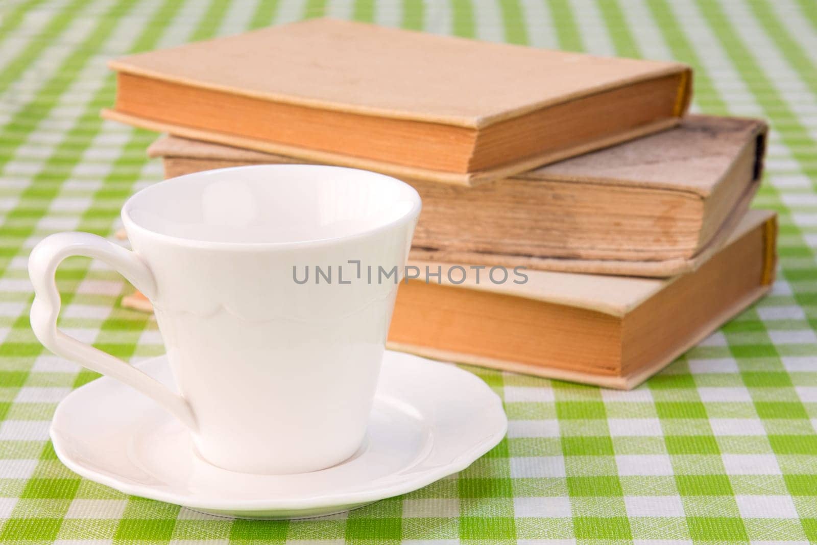 Cup of coffee with books on the table.
