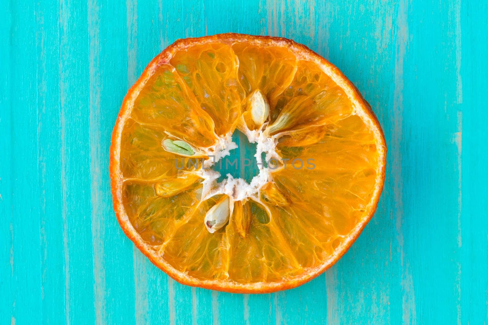 Dry orange fruit on the blue wooden background