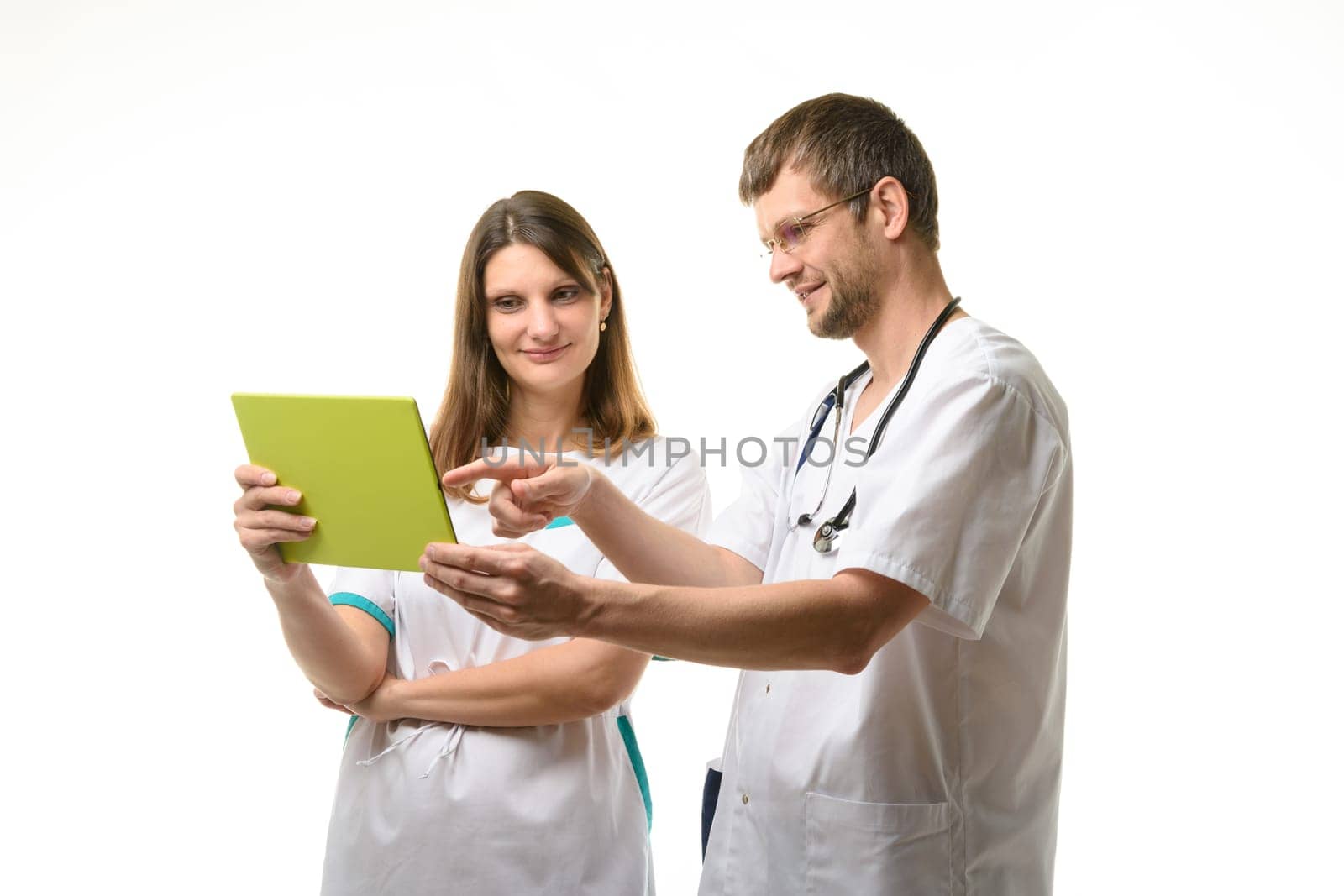 Two doctors discussing the patient's tests while looking at the tablet computer screen