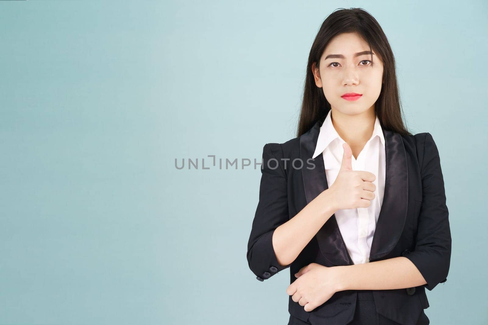 Asian business women in suit and thump up hand sign