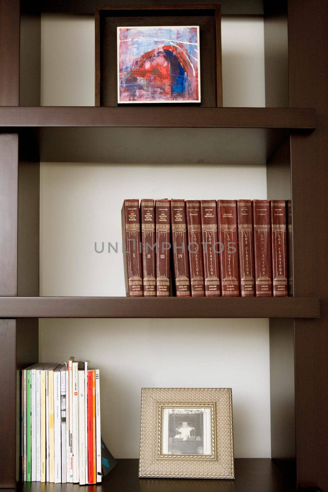 Close-up of books and picture frames in shelves