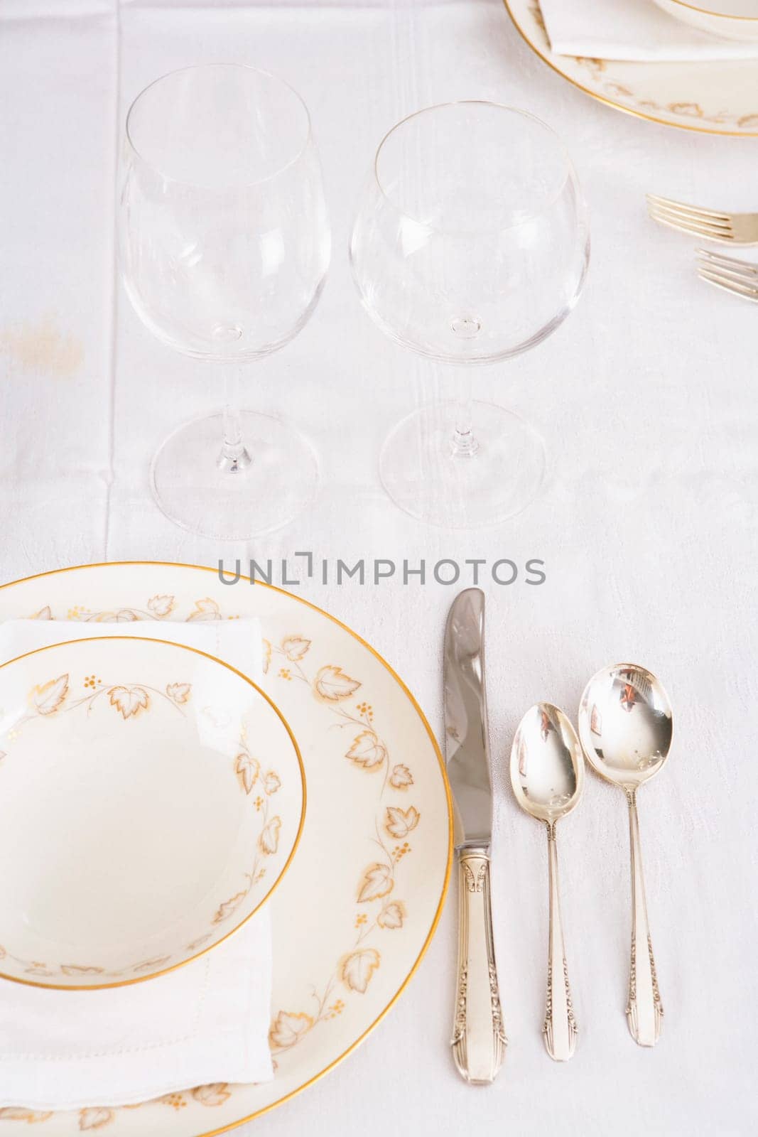 Wine glasses with plates and cutleries on a dining table