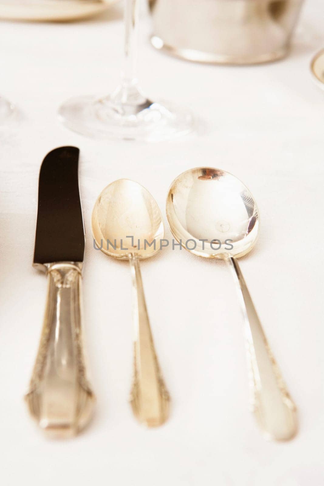 Table knife with two spoons on a dining table