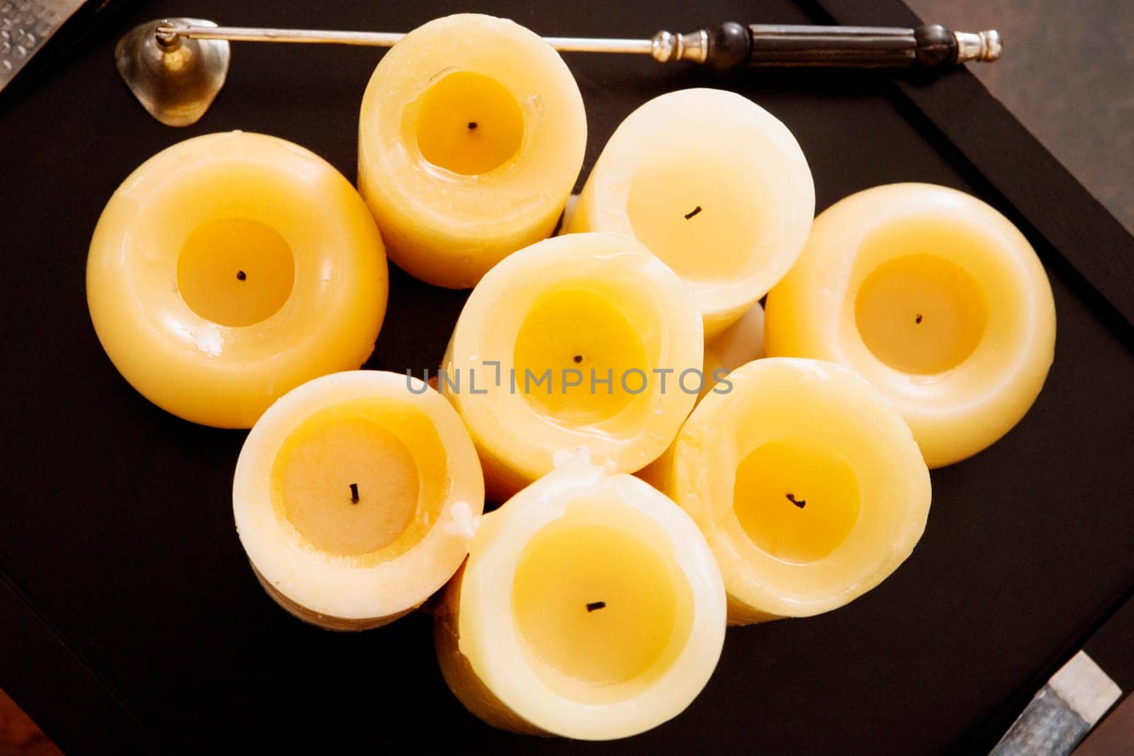 High angle view of candles with a bell in a tray