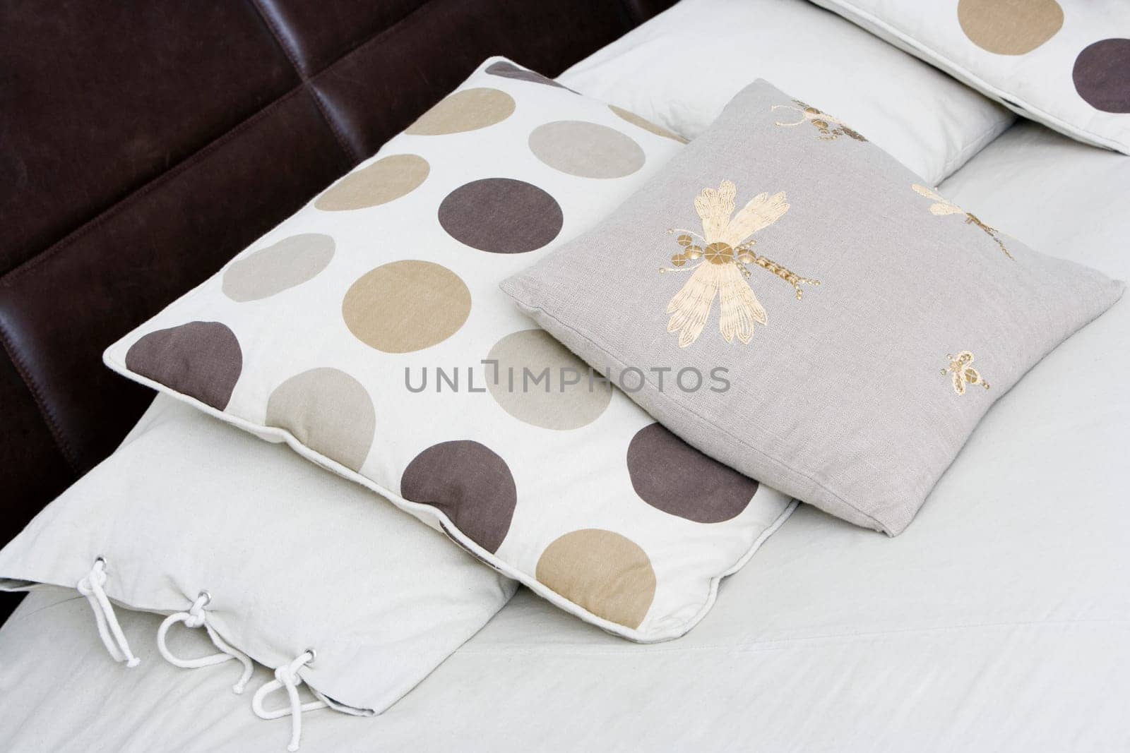 Close-up of cushions and pillows on the bed