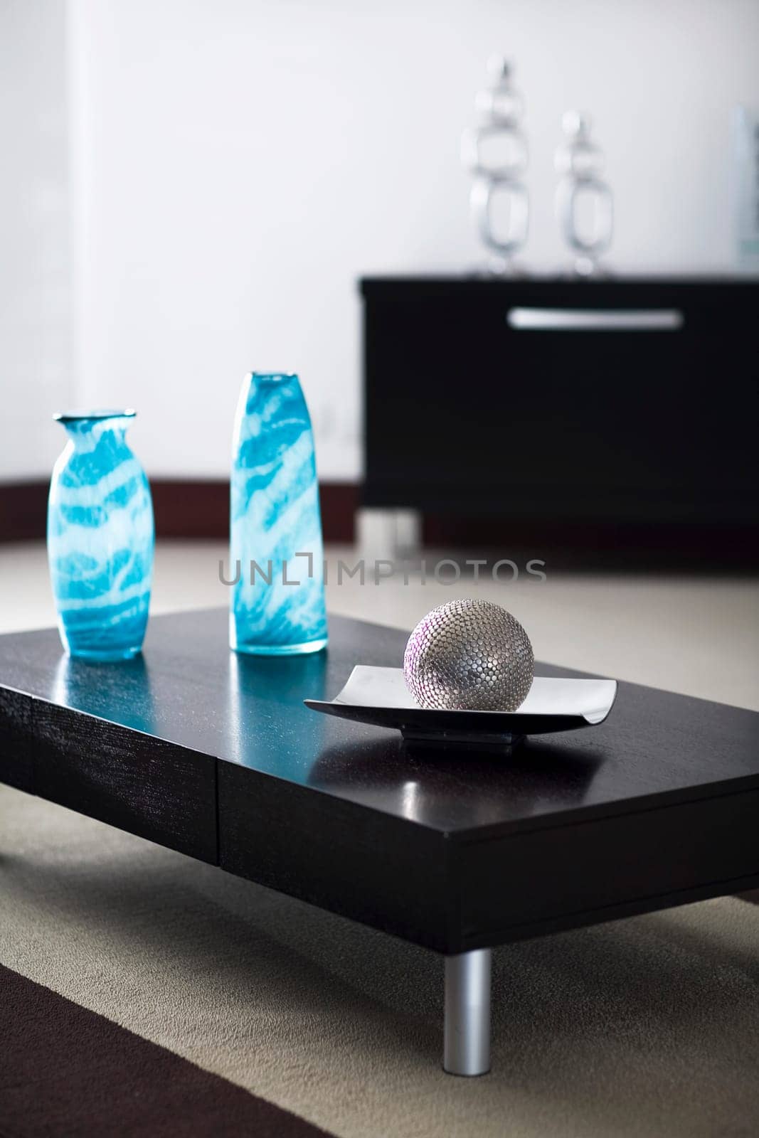 Ball with a tray and two decorative glass vases on a table