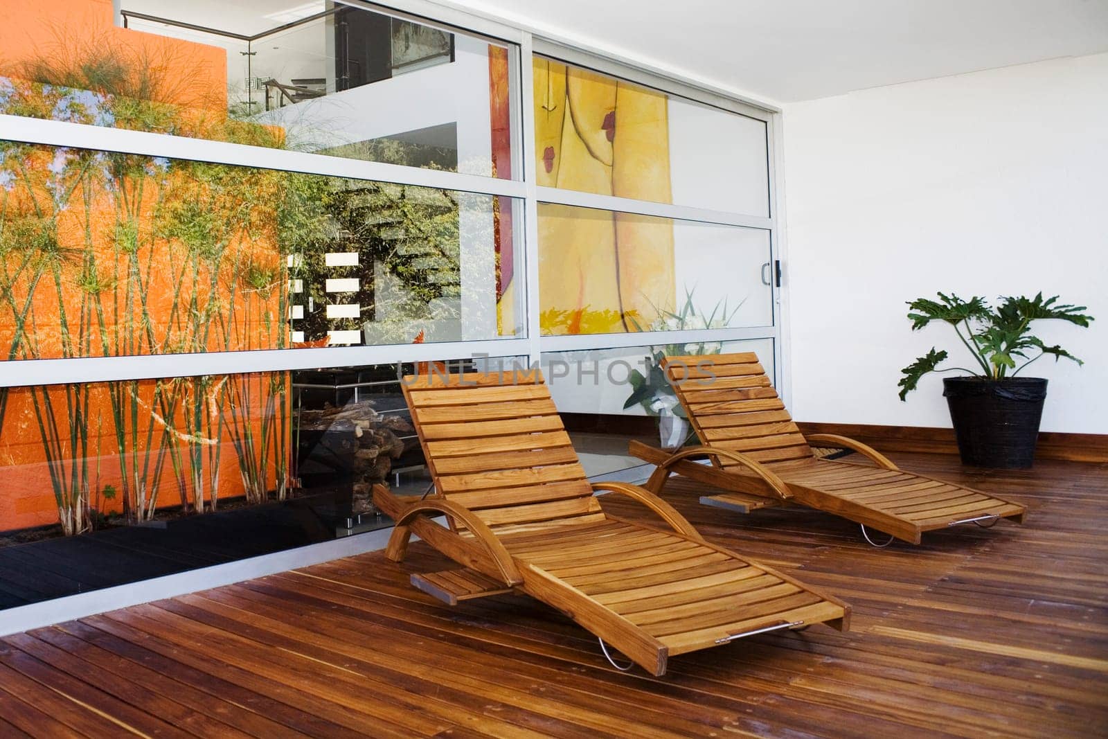 Two lounge chairs in a patio of a house