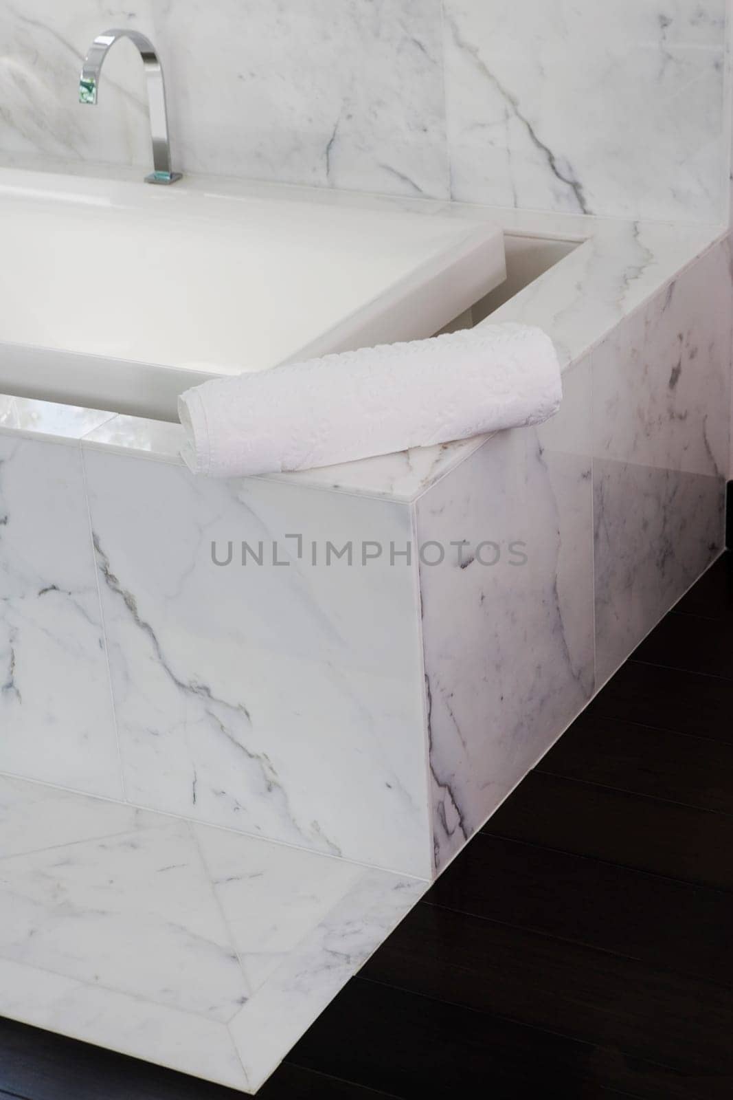 Towel on the ledge of a bathtub