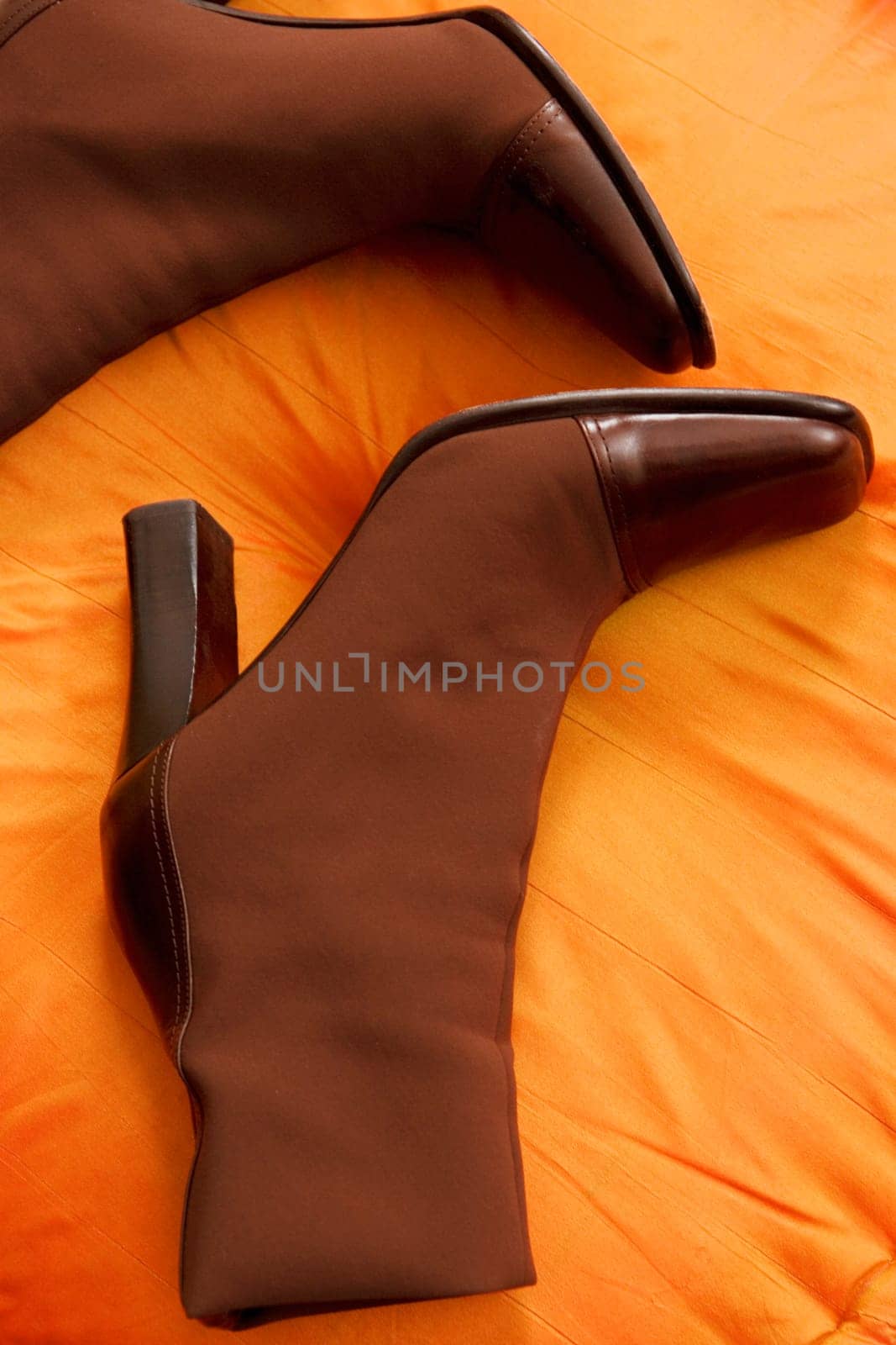 Close_up of a pair of boots on a cushion