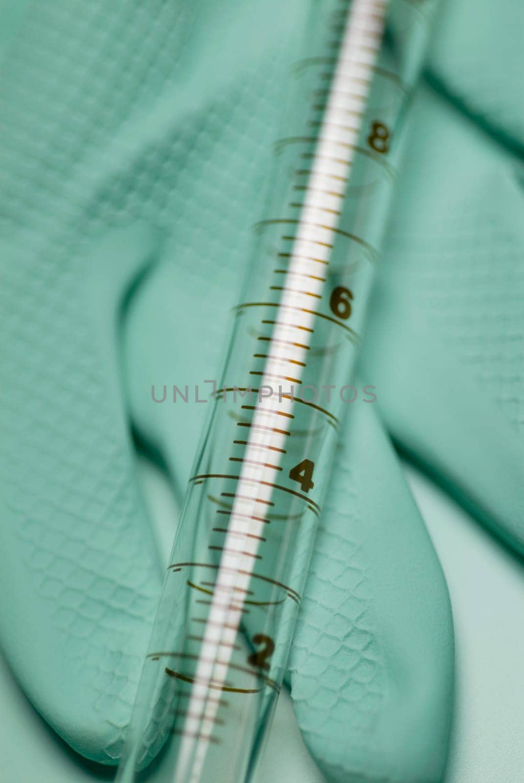 Close_up of a syringe on a glove