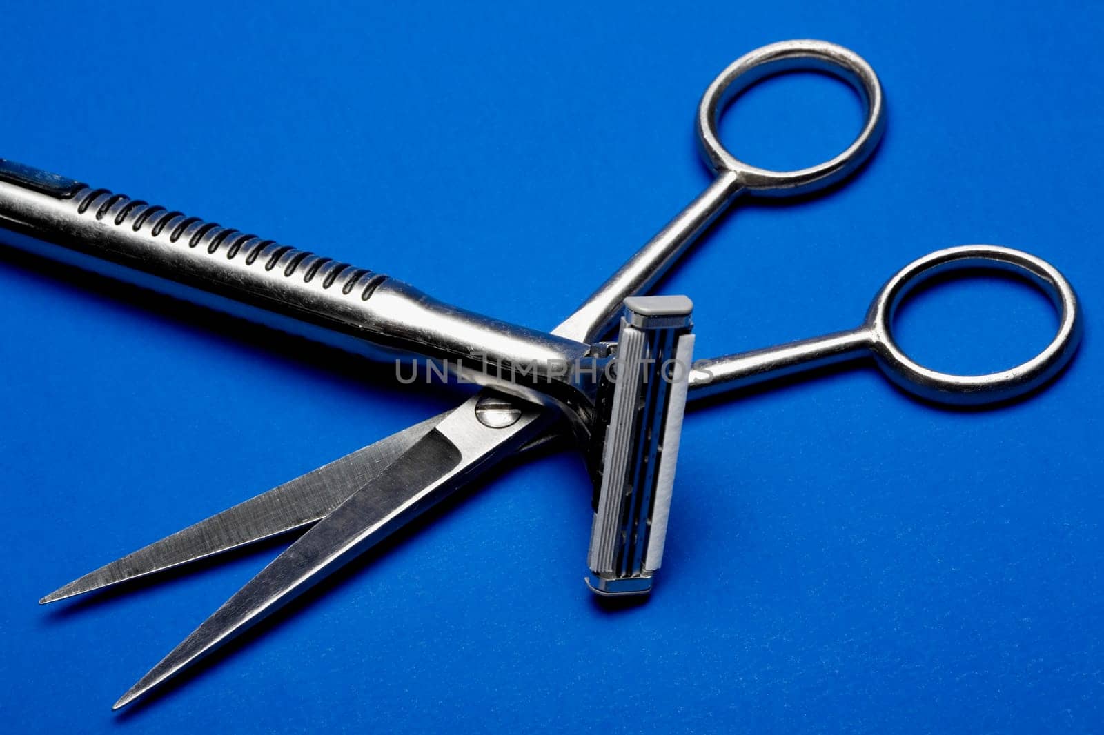 Close-up of a pair of scissors with a razor