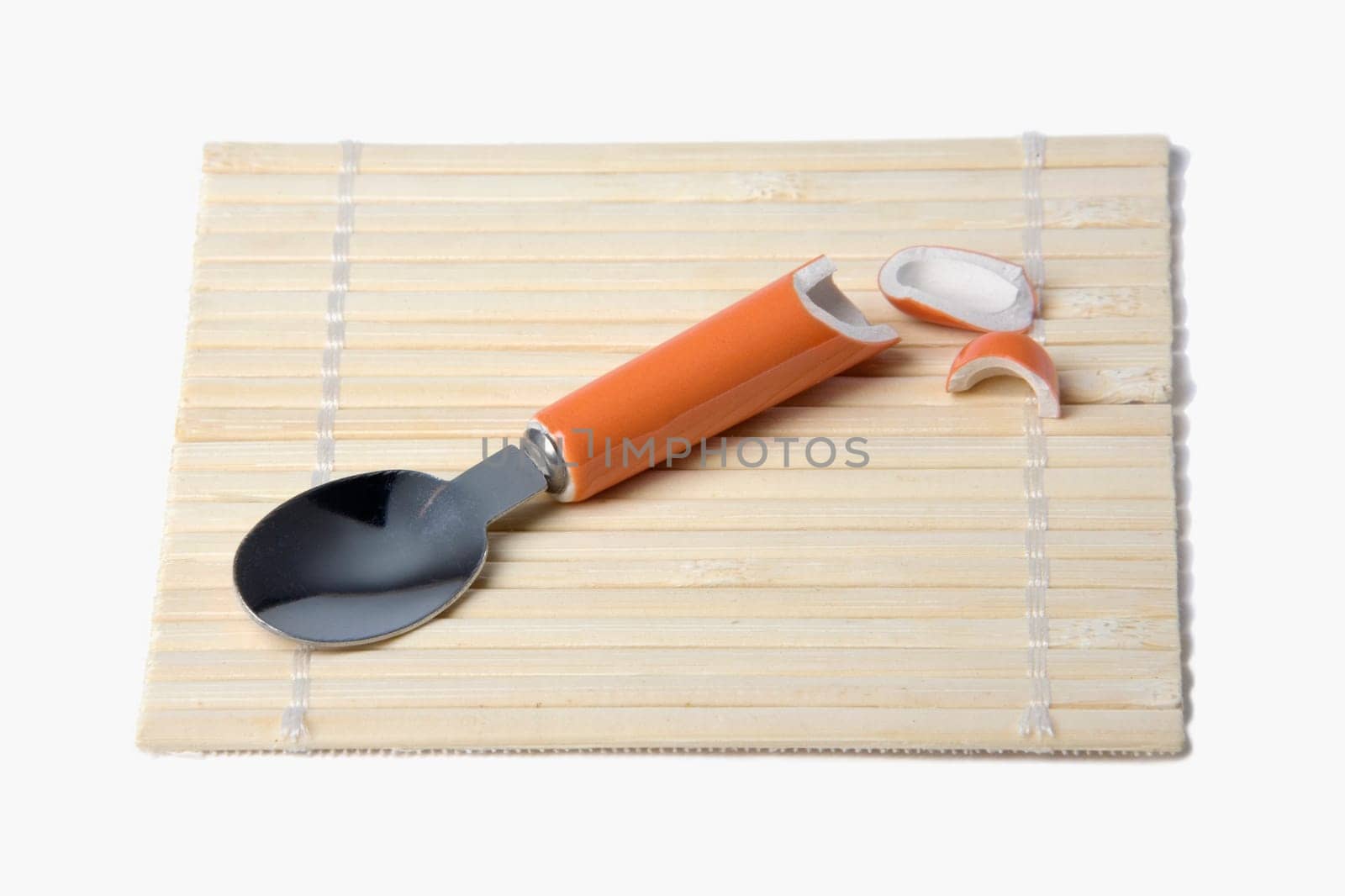 High angle view of a broken spoon on a mat