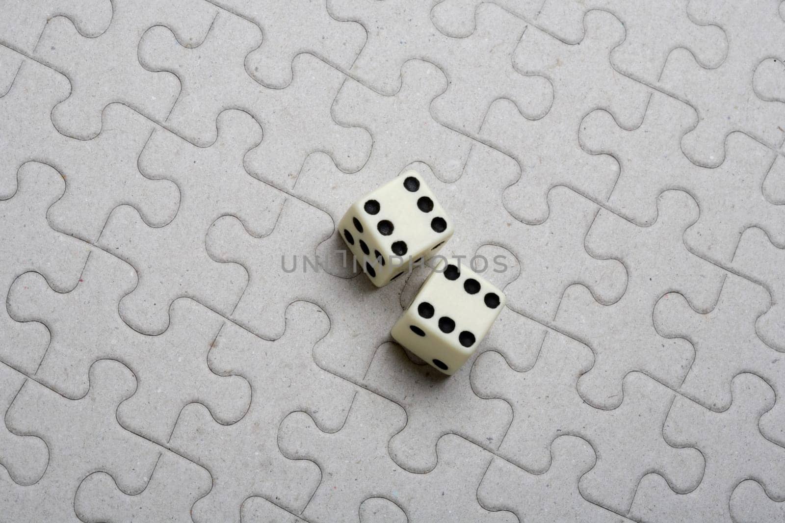 High angle view of a pair of dice on a jigsaw puzzle